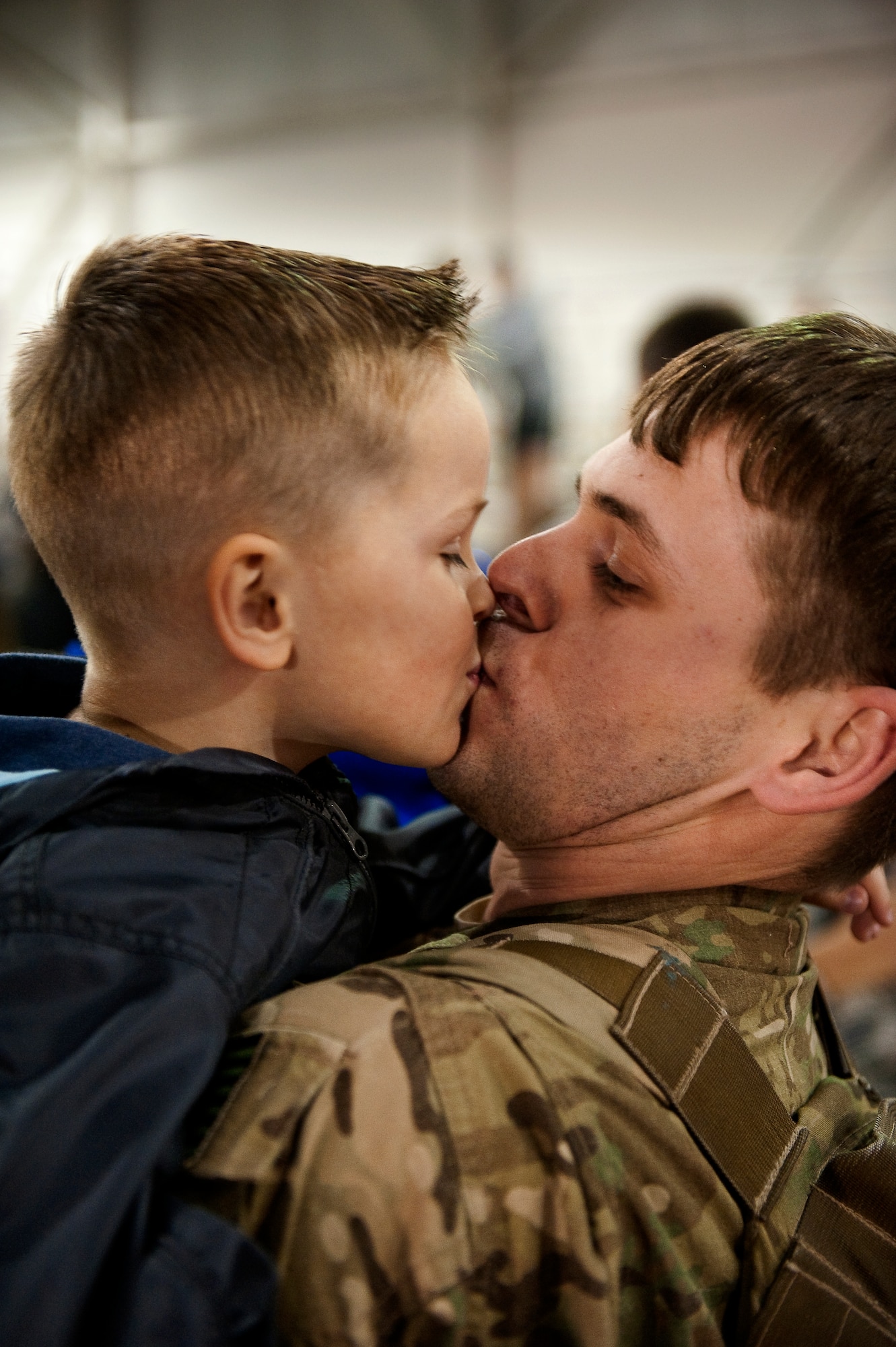 U.S. Air Force Staff Sgt. Casey Strauss, a special operations forces fly away security team from 1st Special Operations Security Forces Squadron, kisses his son Carter at the 16th Aircraft Maintenance Unit hangar on Hurlburt Field, Fla., April 6, 2012. Strauss was met by family members after serving a deployment in support of overseas contingency operations. (U.S. Air Force photo/Airman 1st Class Christopher Williams)