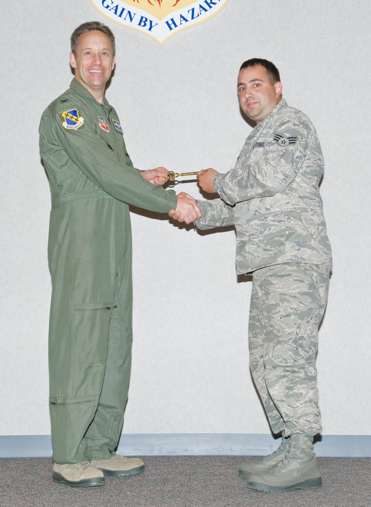 U.S. Air Force Col. Gerald Goodfellow, 7th Bomb Wing vice commander, presents the honorary key to Joshua Jacobs, 317th Aircraft Maintenance Squadron, on behalf of Staff Sgt. James Standish, 317th AMXS, April 18, 2012 at Dyess Air Force Base, Texas. The aircraft is the 18th of 28 to be delivered to Dyess, replacing the legacy fleet of the C-130 Hercules model. (U.S. Air Force photo by Airman 1st Class Jonathan Stefanko/ Released)