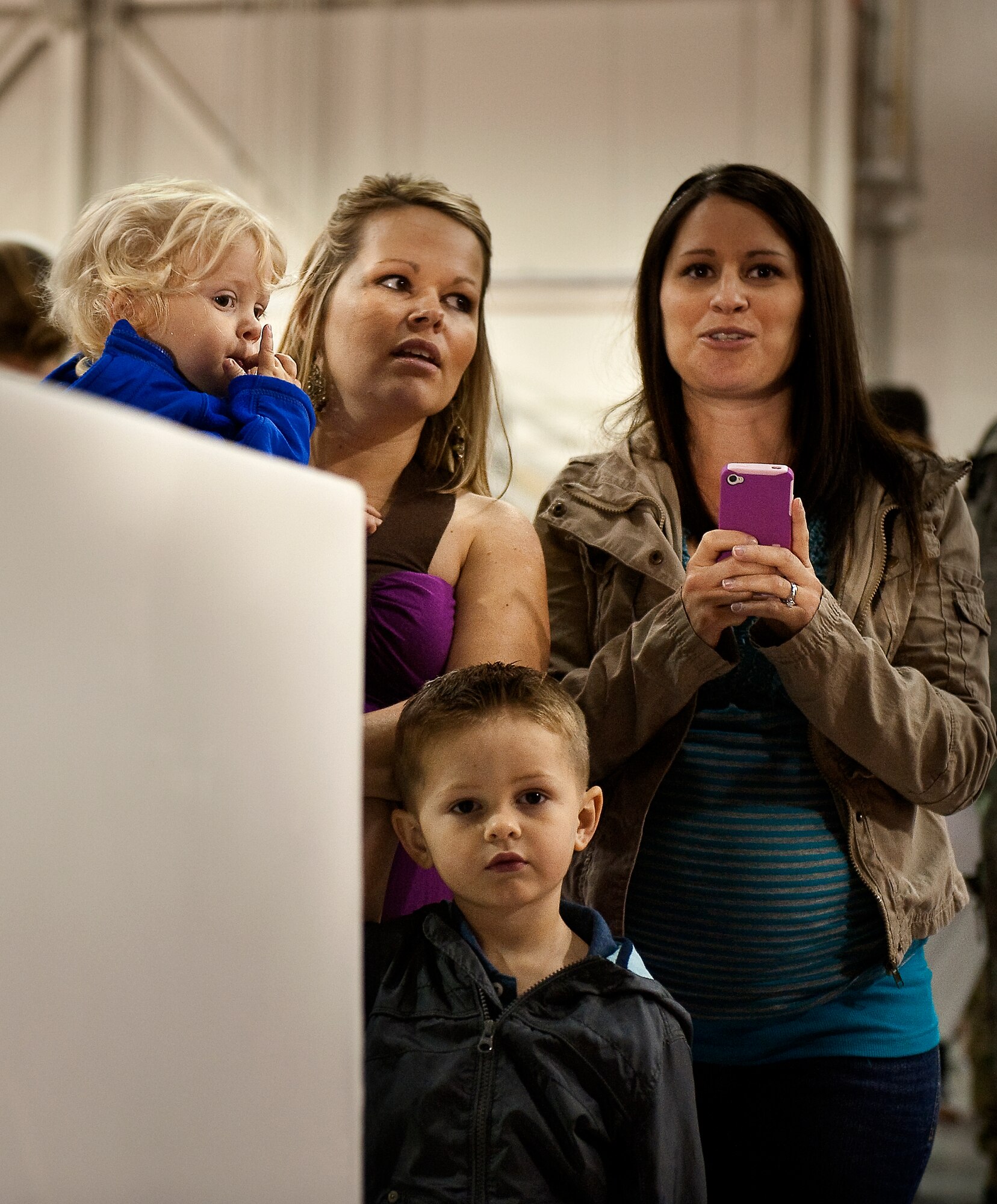 Family members of U.S. Air Force Staff Sgt. Casey Strauss, a special operations force fly away security team from 1st Special Operations Security Forces Squadron, wait for Strauss to return from deployment while at the 16th Aircraft Maintenance Unit hangar on Hurlburt Field, Fla., April 6, 2012. Family members arrived to greet their returning loved ones in support of overseas contingency operations. (U.S. Air Force photo/Airman 1st Class Christopher Williams)(Released)
