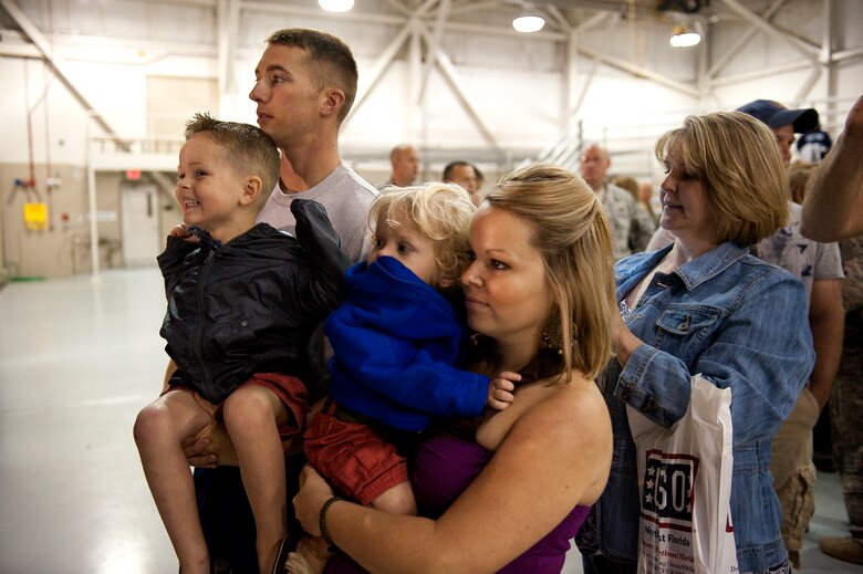 Family members of U.S. Air Force Staff Sgt. Casey Strauss, a special operations force fly away security team from 1st Special Operations Security Forces Squadron, wait for Strauss to return from a deployment while at the 16th Aircraft Maintenance Unit hangar on Hurlburt Field, Fla., April 6, 2012. Family members arrived hours before the plane was scheduled to land to welcome their service members home. (U.S. Air Force photo/Airman 1st Class Christopher Williams)(Released)