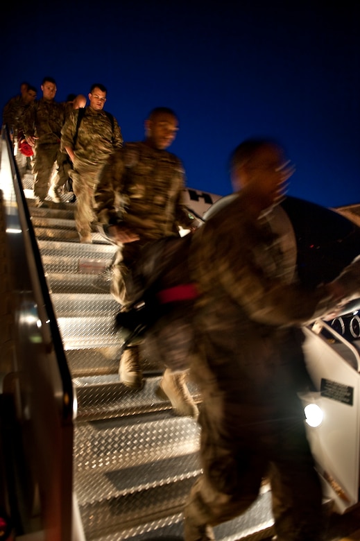 U.S. Air Force Airmen disembark from an aircraft on the flight line on Hurlburt Field, Fla., April 6, 2012. The members have been deployed in support of overseas contingency operations. (U.S. Air Force photo/Airman 1st Class Christopher Williams)(Released)