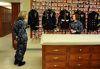 Navy Rear Adm. Martha Herb, Deputy, Navy Personnel Command Director Personal Readiness and Community Support, Washington, DC., listens as Petty Officer 2nd Class Jennifer Howell explains the mission of the uniform section at the Charles C. Carson Center for Mortuary Affairs April 9, 2012. Howell, a Navy mortician is assigned to the Navy and Marine Corps Liaison office. Herb toured the mortuary and the Center for Families of the Fallen. (U.S. Air Force photo/Tech. Sgt. Myco Apat)