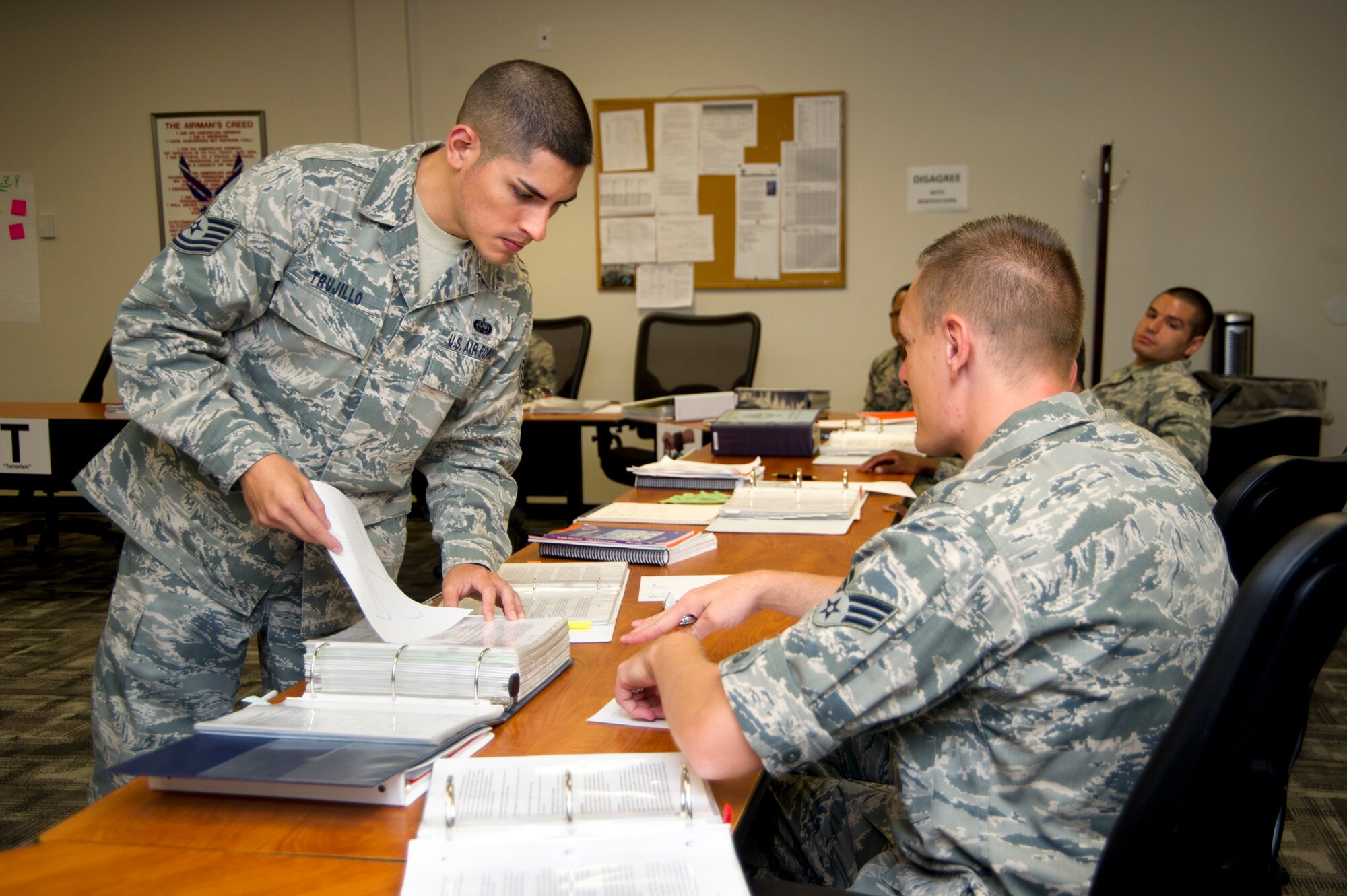 Tech. Sgt.  Alberto Trujillo, 81st Force Support Squadron, shows Senior Airman Michael Coblentz, 81st Training Wing, the solutions to a group communications exercise in which students attempt to redraw a shape solely from instruction from a classmate during Airman Leadership School at Keesler Air Force Base, Miss., April 11, 2012.  (U.S. Air Force photo by Adam Bond)