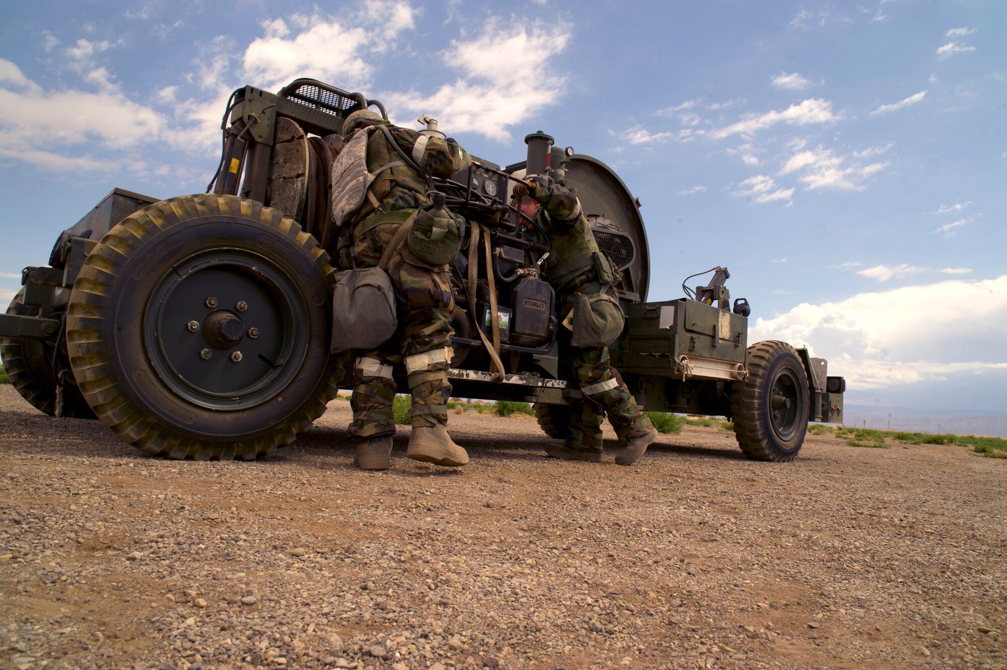 HOLLOMAN AIR FORCE BASE, N.M. – Airmen from the 49th Civil Engineer and Materiel Maintenance Squadrons prepare to place a Mobile Aircraft Arrest System during a Bivouac exercise April 11. The MAAS deploys a large cable similar to that seen on naval aircraft carriers to allow an aircraft to land on a space limited runway. (U.S. Photo by Airman 1st Class Michael Shoemaker/Released)