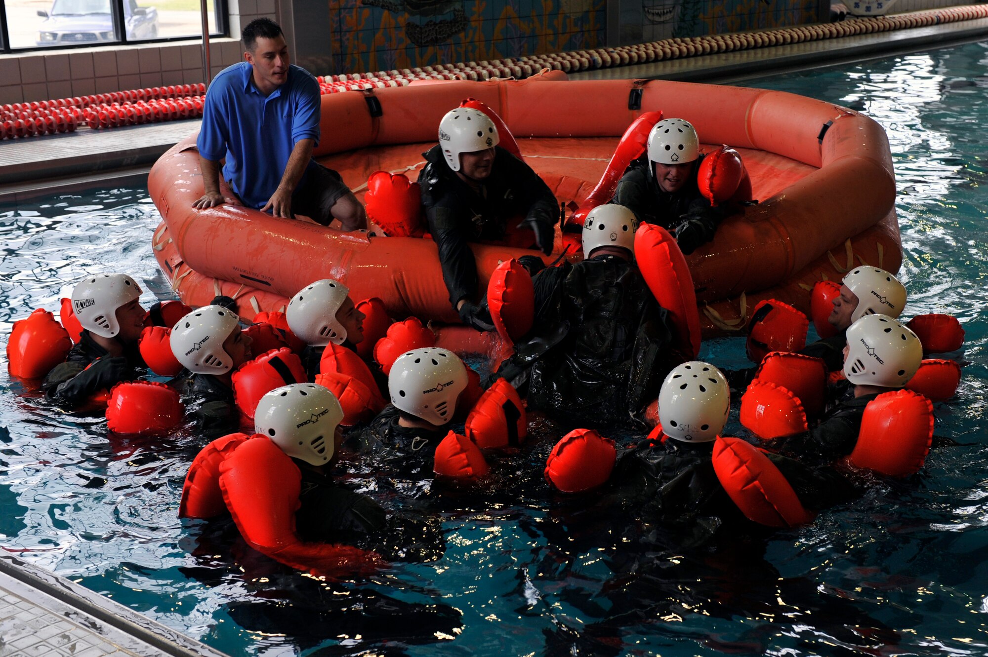 Team Little Rock members learn how to get into a raft during water survival training, April 13, 2012, at Jacksonville, Ark. Learning how to get into a life raft was one of the techniques taught during water survival training. (U.S. Air Force photo by Airman 1st Class Rusty Frank)