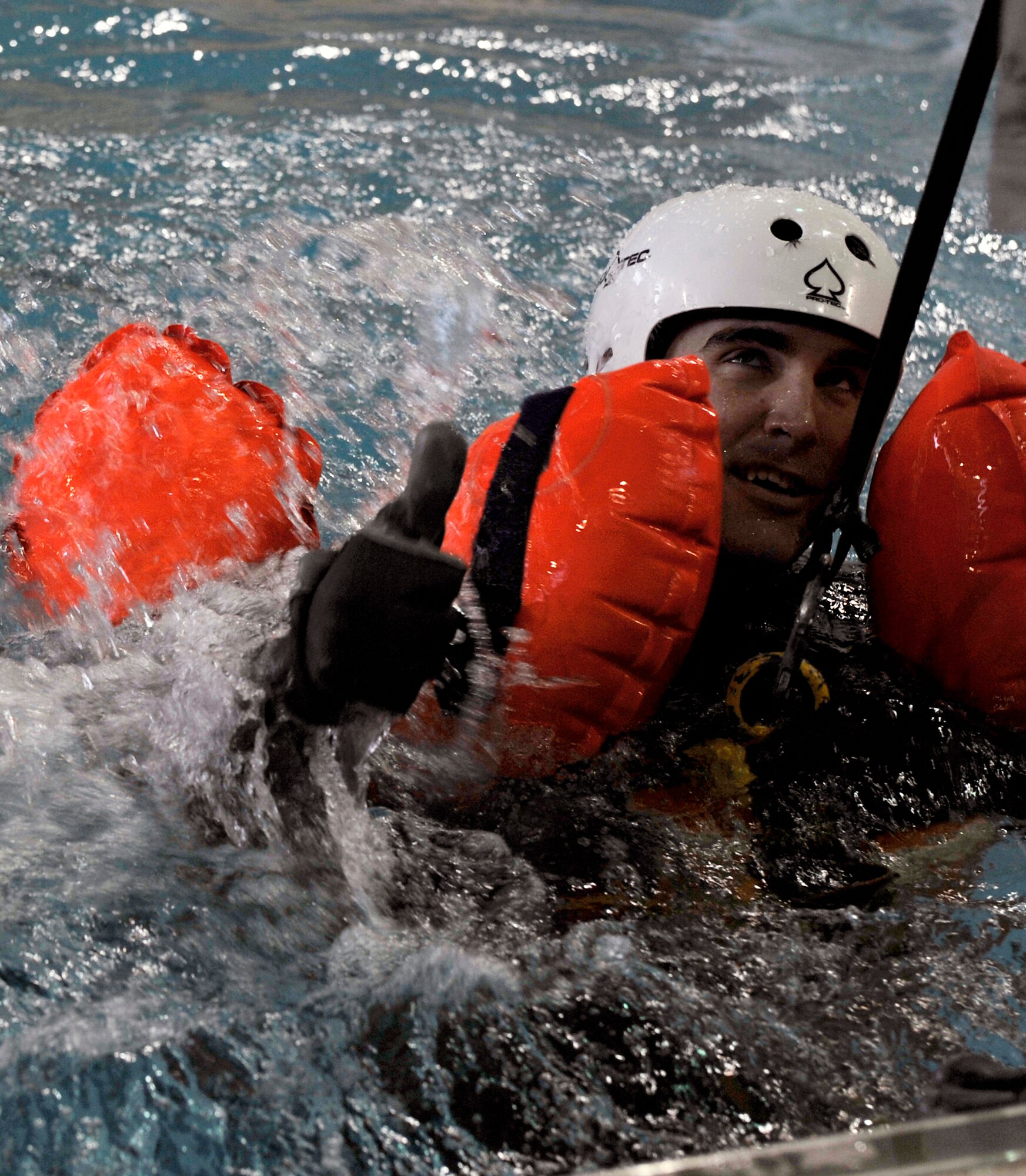 A Team Little Rock member gives the thumbs up during water survival training, April 13, 2012, at Jacksonville, Ark. During the water survival training Team Little Rock members learned how to hook into penetrators, a device used for hoisting people out of the water. (U.S. Air Force photo by Airman 1st Class Rusty Frank)