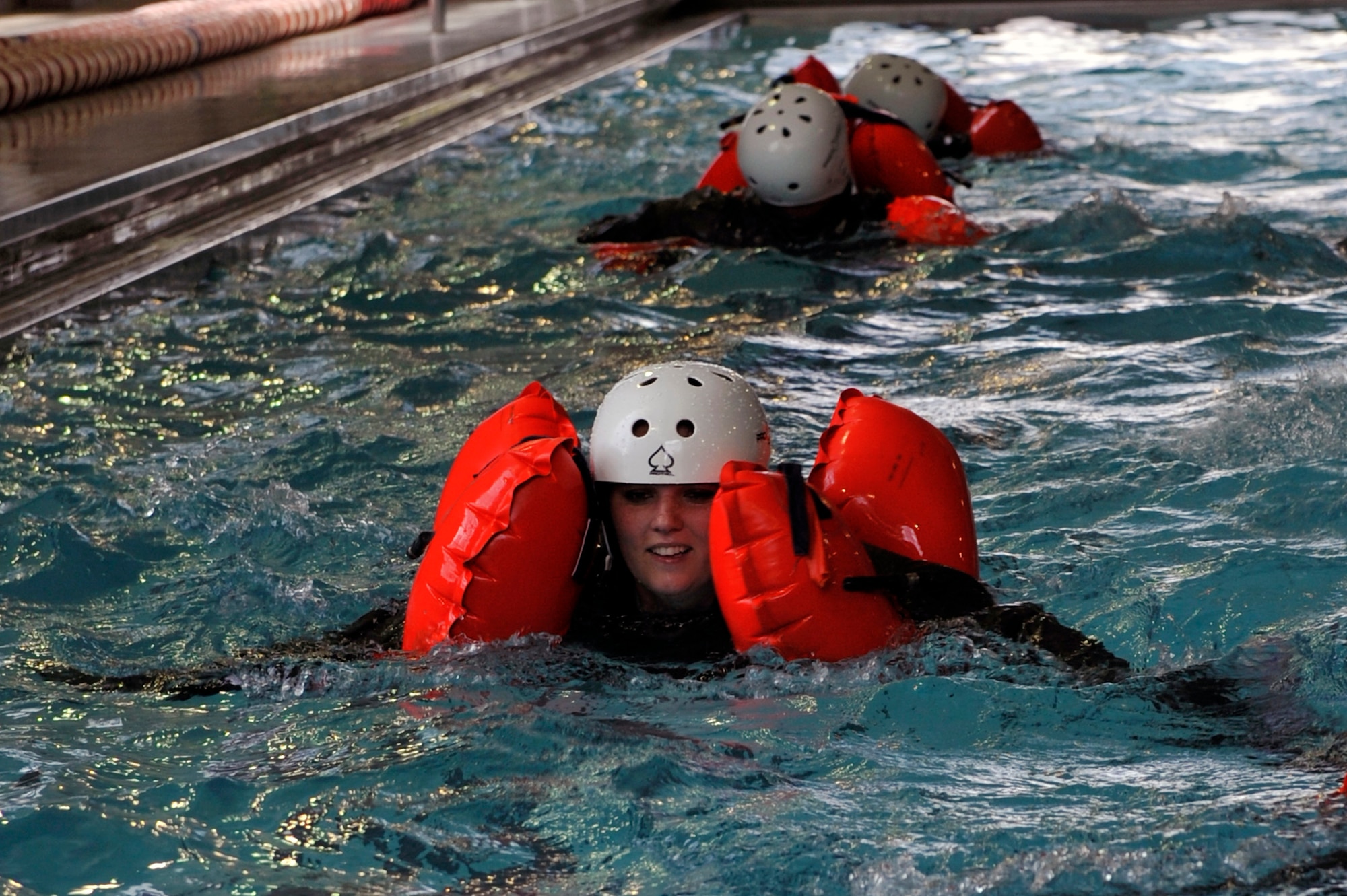 Senior Airman Rachael Orazine, a 41st Airlift Squadron loadmaster, swims during water survival training, April 13, 2012, at Jacksonville, Ark. Aircrew members must go through a water survival training refresher course once a year. (U.S. Air Force photo by Airman 1st Class Rusty Frank)