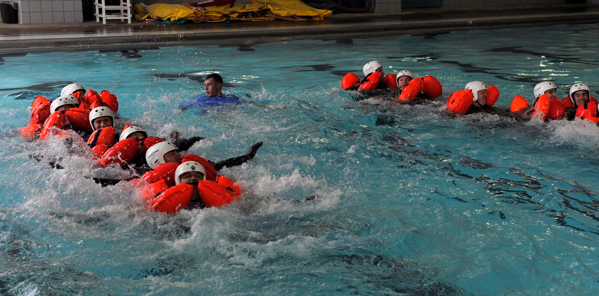 Staff Sgt. Steve McNair, a 19th Operations Squadron Support Squadron Survival Evasion Resistance Escape specialist, teaches swimming techniques during water survival training, April 13, 2012, inside the Jacksonville Community Center, at Jacksonville, Ark.  McNair and the other SERE specialist teach two weeks a month of combat survival training. (U.S. Air Force photo by Airman 1st Class Rusty Frank)