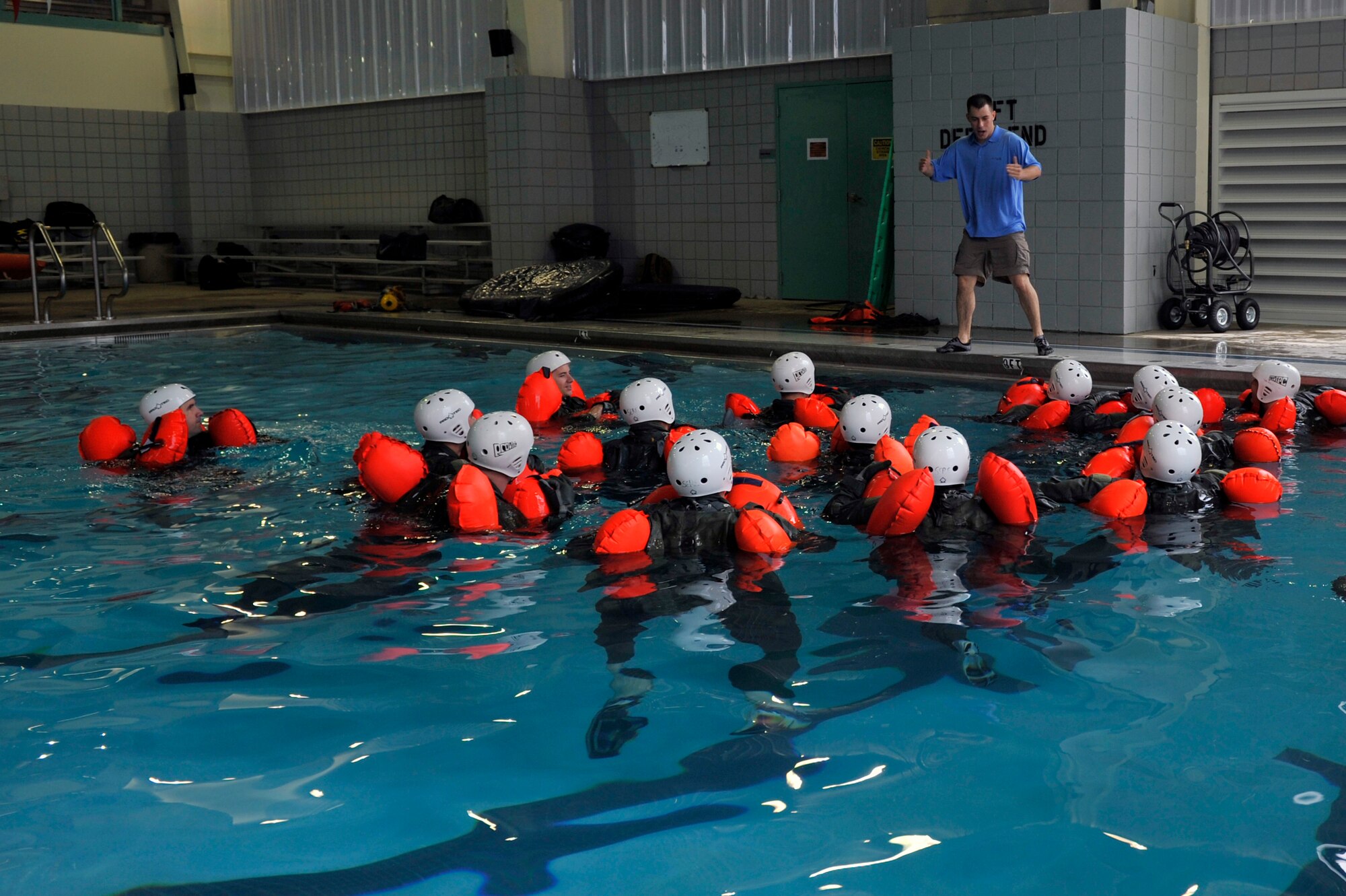 Staff Sgt. Steve McNair, a 19th Operations Squadron Support Squadron Survival Evasion Resistance Escape specialist, teaches swimming techniques during water survival training, April 13, 2012, inside the Jacksonville Community Center, at Jacksonville, Ark.  McNair and the other SERE specialist teach two weeks a month of combat survival training. (U.S. Air Force photo by Airman 1st Class Rusty Frank)