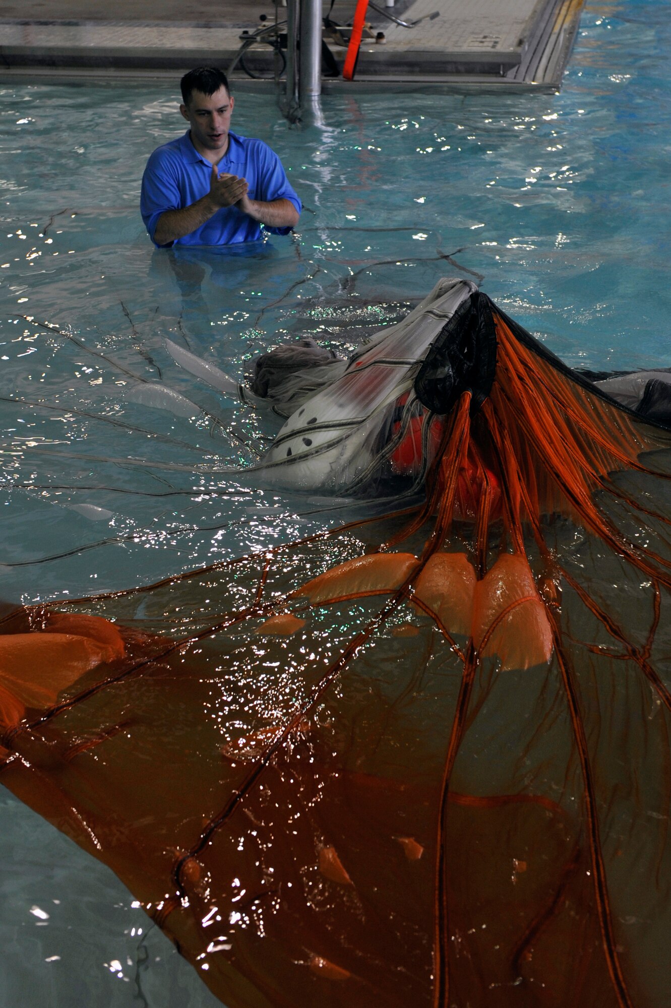 Staff Sgt. Steve McNair, a 19th Operations Support Squadron Survival Evasion Resistance Escape specialist, teaches a member of Team Little Rock how to escape a canopy during water survival training, April 13, 2012, at Jacksonville, Ark. Escaping a canopy was one to the techniques taught during the water survival training class. (U.S. Air Force photo by Airman 1st Class Rusty Frank)