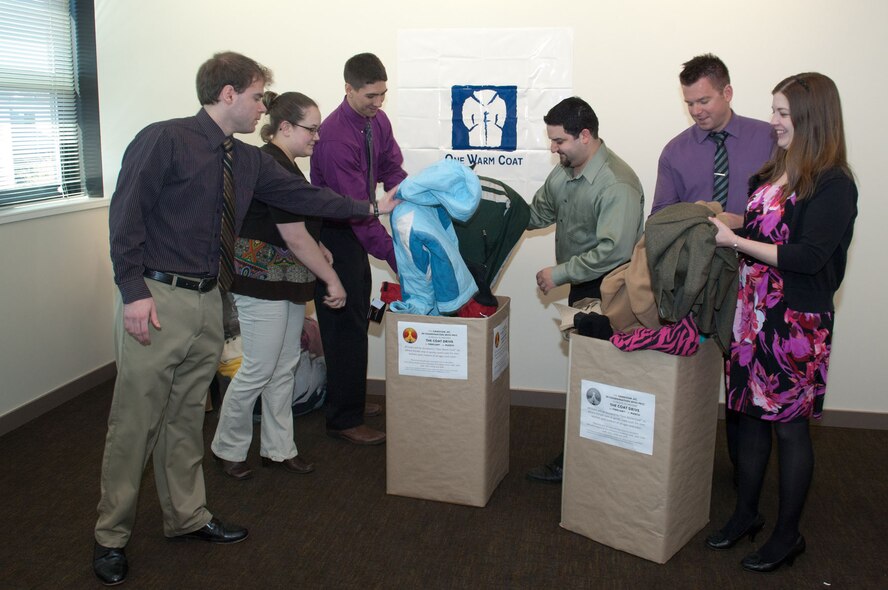 HANSCOM AIR FORCE BASE, Mass. – Members of the Junior Force Council (from left to right), Billy Robinson, Lauren Reed-Smart, Daniel Dornfeld, Paul Pollard, Chris Molis and Jenny Carrion, pack up coats on April 3. JFC and the PK Intern Council sponsored a coat drive throughout the month of March and will take all donations to One Warm Coat. (U.S. Air Force photo by Rick Berry)