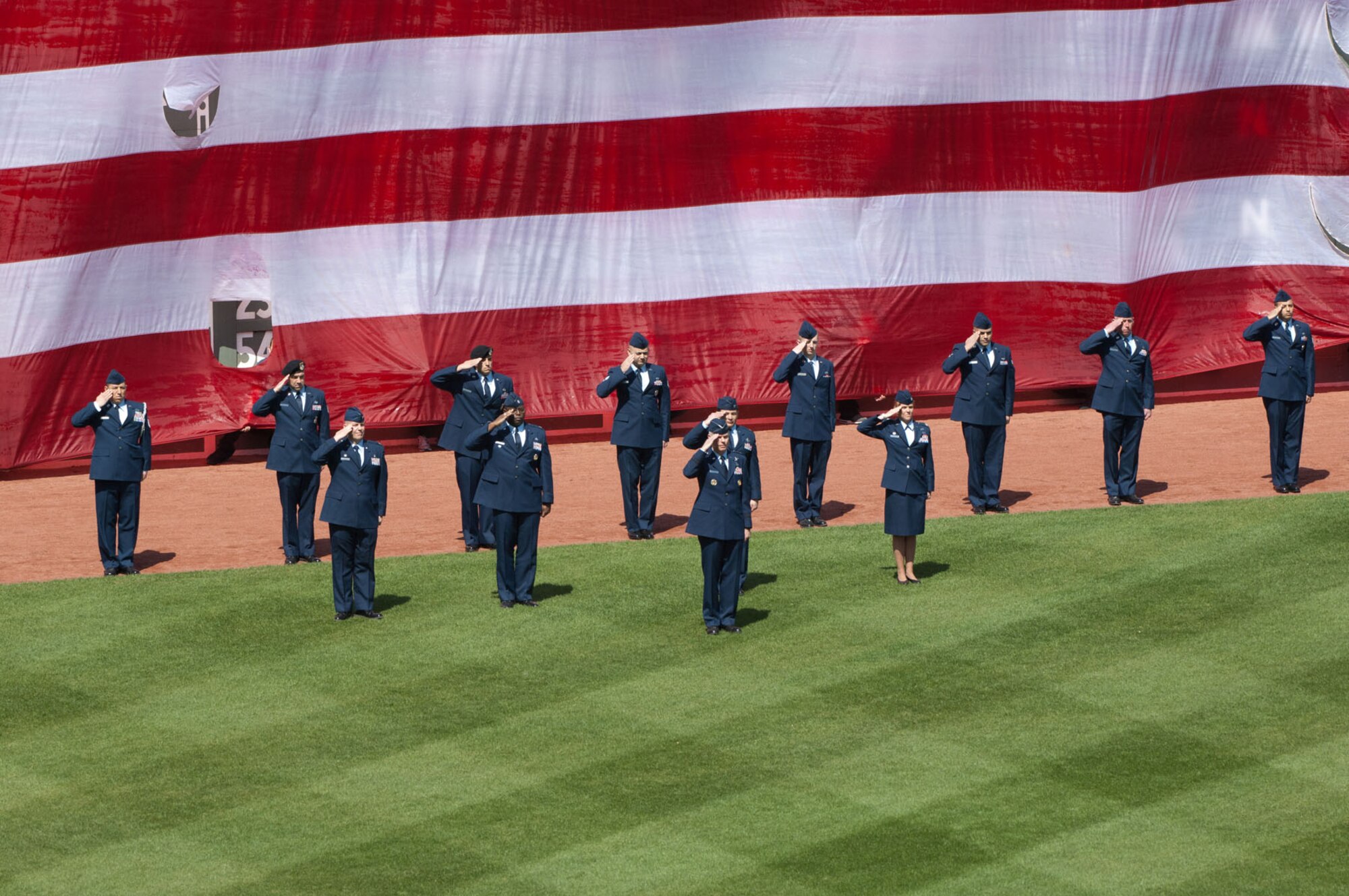BOSTON, Mass. – Hanscom Airmen, led by Lt. Gen. CR Davis (front), Electronic Systems Center commander, render honors during the playing of the national anthem at Fenway Park for the Boston Red Sox home opener April 13. The Airmen were on the field as part of opening day ceremonies. (U.S. Air Force photo by Rick Berry)