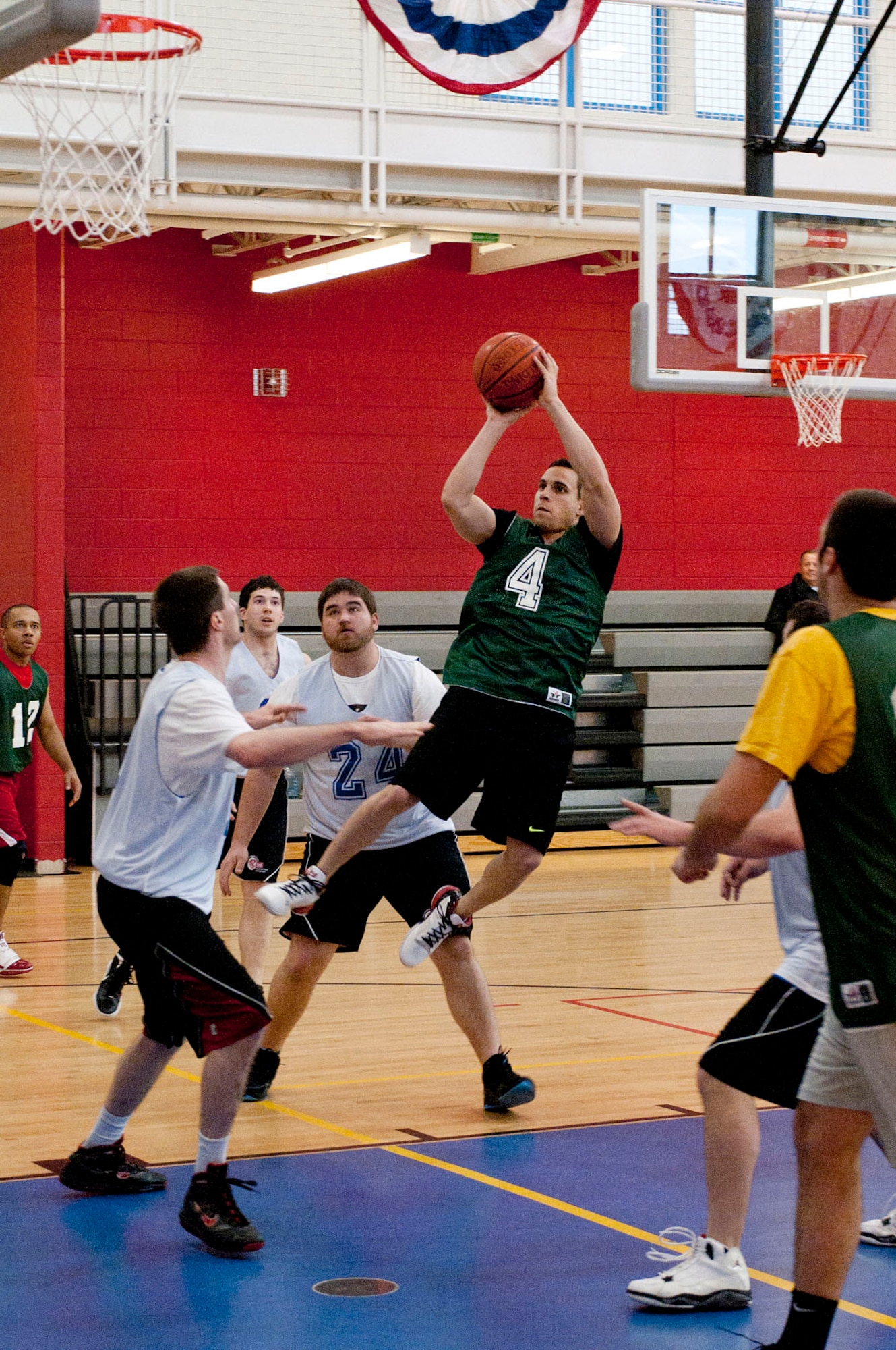 HANSCOM AIR FORCE BASE, Mass. – 2nd Lt. Matthew Alva, playing for Battle Management, shoots over Army defenders during the base intramural championship game at the Fitness Center April 10. The Army defeated HB in double overtime, 37 to 32. (U.S. Air Force photo by Mark Wyatt)