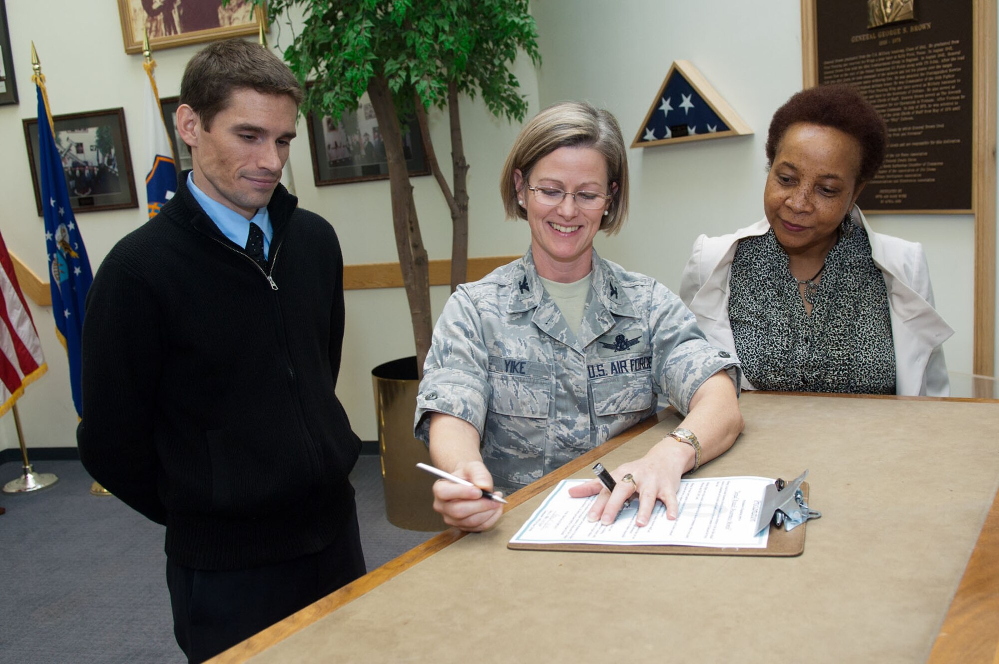 HANSCOM AIR FORCE BASE, Mass. – Col. Stacy L. Yike, 66th Air Base Group commander, along with Andrea Mckie, incoming Sexual Assault Response coordinator, and Matt Nicoli, Family Advocacy Program, sign a proclamation declaring April as Sexual Assault Awareness Month on base. The theme of this month’s observance is “Hurts One, Affects All.” (U.S. Air Force photo by Rick Berry)