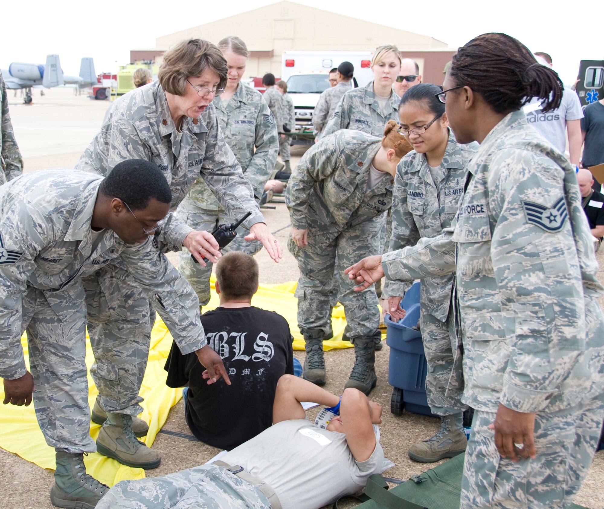 Members of Team Barksdale treat an Airman with simulated injuried during a Major Accident Response Exercise on Barksdale Air Force Base, La., April 13. Airmen from the 2nd Medical Group were evaluated on how promptly and effectively they responded to the simulated injuries and casualties during the incident. (U.S. Air Force photo/Airman 1st Class Benjamin Gonsier)(RELEASED)
