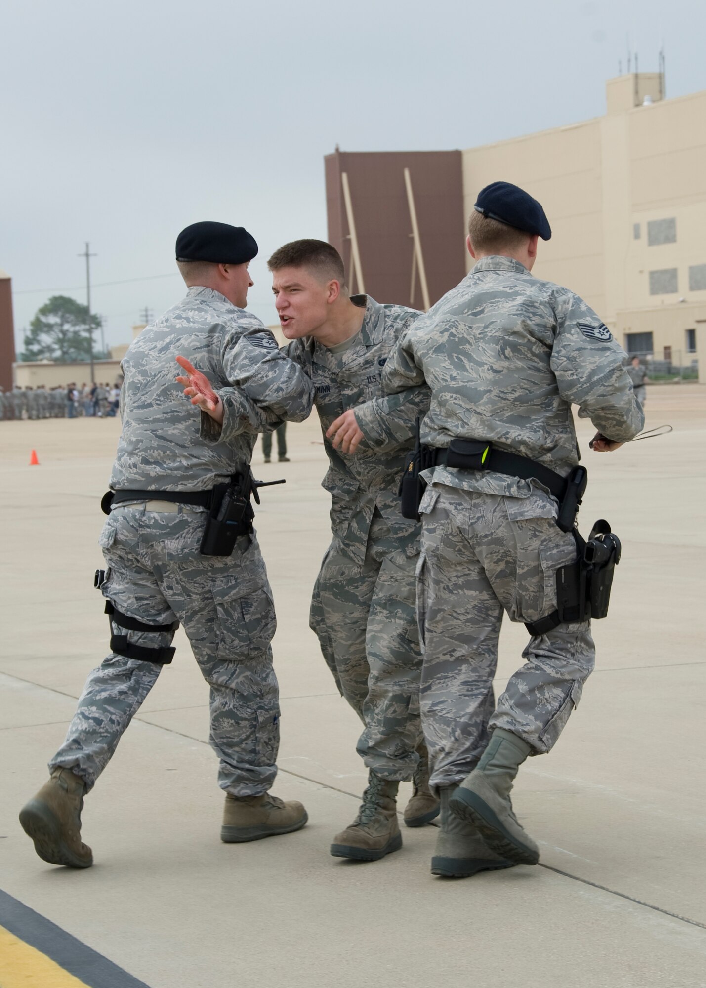 A Barksdale Airman acts unruly as members of the 2nd Security Forces Squadron restrain him during a Major Accident Response Exercise on Barksdale Air Force Base, La., April 13. Members of Team Barksdale were evaluated on how promptly and effectively they responded to simulated casualties and personnel acting out of control. (U.S. Air Force photo/Airman 1st Class Benjamin Gonsier)(RELEASED)
