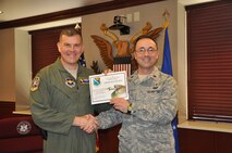 Maj. Dwayne Keener, 47th Flying Training Wing chaplain, poses with Col. James Jinnette , 47th FTW vice commander, after being presented the Cost Conscious Culture award  April 17, 2012, at Laughlin Air Force Base, Texas. C3 is a monthly award that is given to a person or unit that makes the largest impact on Laughlin’s mission to reduce energy consumption and save money. The chapel converted from a primarily paper and labor induced advertising system to a simple electronic and affordable system that will save $200 annually while freeing up manpower. (U.S. Air Force photo/2nd Lt. Angela Martin)