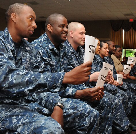 Sailors hold up stop signs during an audience participation event at the ‘Sex Signals’ show at the RedBank Club at Joint Base Charleston – Weapons Station April 18. The program uses humor, improvisation and audience participation to put a new up-to-date spin on the issue of sexual assault. (U.S. Navy photo/ Petty Officer 1st Class Jennifer Hudson)