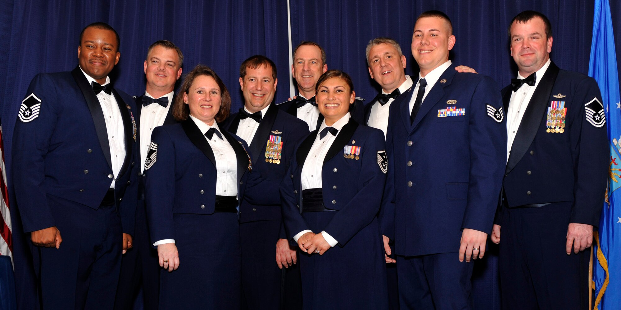 Members of the 512th Operations Group celebrate with Master Sgt. Misty Ruffo (center), 326th Airlift Squadron first sergeant, at the 512th Airlift Wing's 7th Annual Senior NCO Induction Ceremony April 14, 2012, at the Landings, Dover Air Force Base, Del. The 512th Top 3 Association hosted the evening dinner event. (U.S. Air Force photo/Tech. Sgt. Charles Walker)