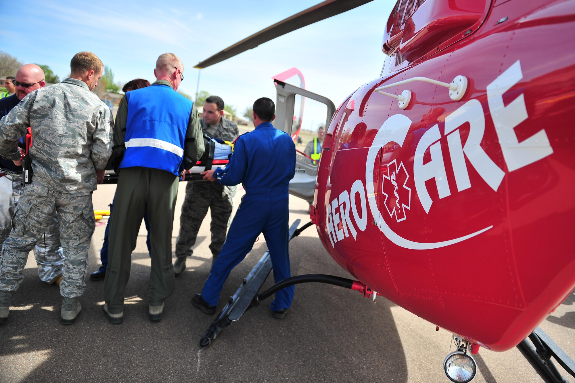 Cannon Air Commandos and life flight helicopter crew members load a simulated tornado victim onboard during natural disaster exercise at Cannon Air Force Base, N.M., April 5, 2012. Training exercises provide a safe and controlled environment to practice tactics, techniques and procedures. (U.S. Air Force photo by Tech. Sgt. Josef Cole)