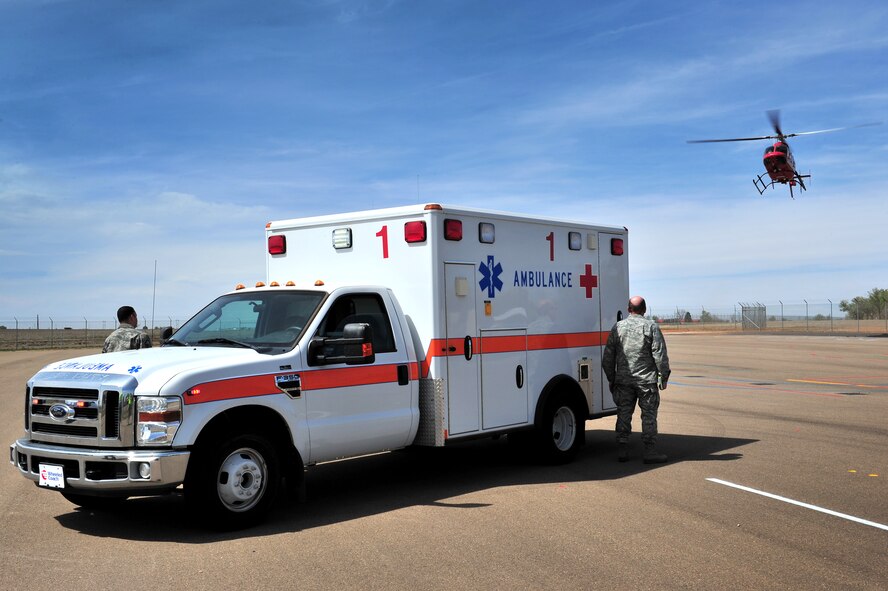 Cannon Air Commandos stand ready as a life flight helicopter arrives to participate in a natural disaster exercise at Cannon Air Force Base, N.M., April 5, 2012. Training exercises provide a safe and controlled environment to practice tactics, techniques and procedures. (U.S. Air Force photo by Tech. Sgt. Josef Cole)