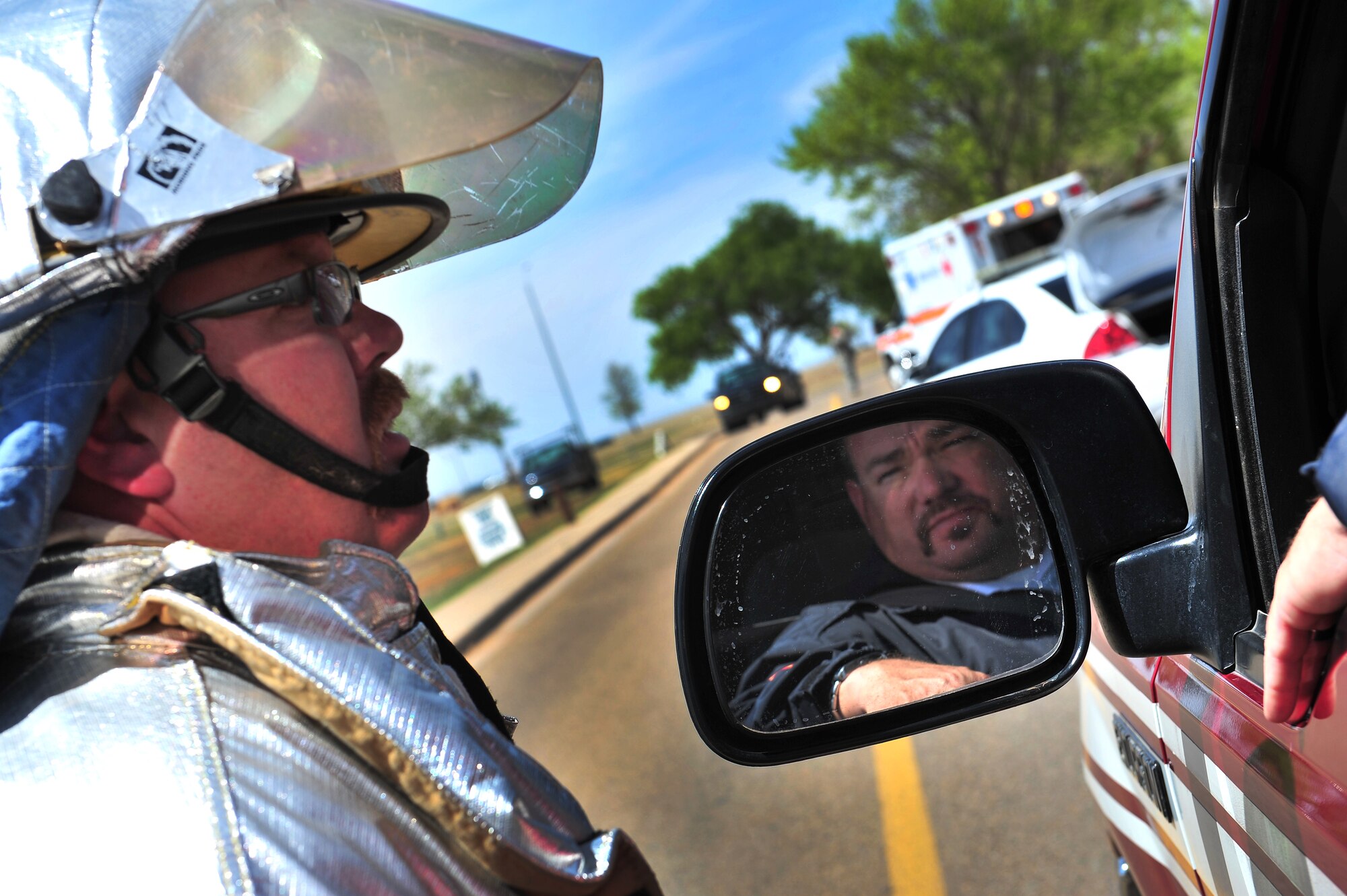 Firefighters exchange information at the scene of a simulated tornado during a natural disaster exercise at Cannon Air Force Base, N.M., April 5, 2012. Training exercises provide a safe and controlled environment to practice tactics, techniques and procedures. (U.S. Air Force photo by Tech. Sgt. Josef Cole)