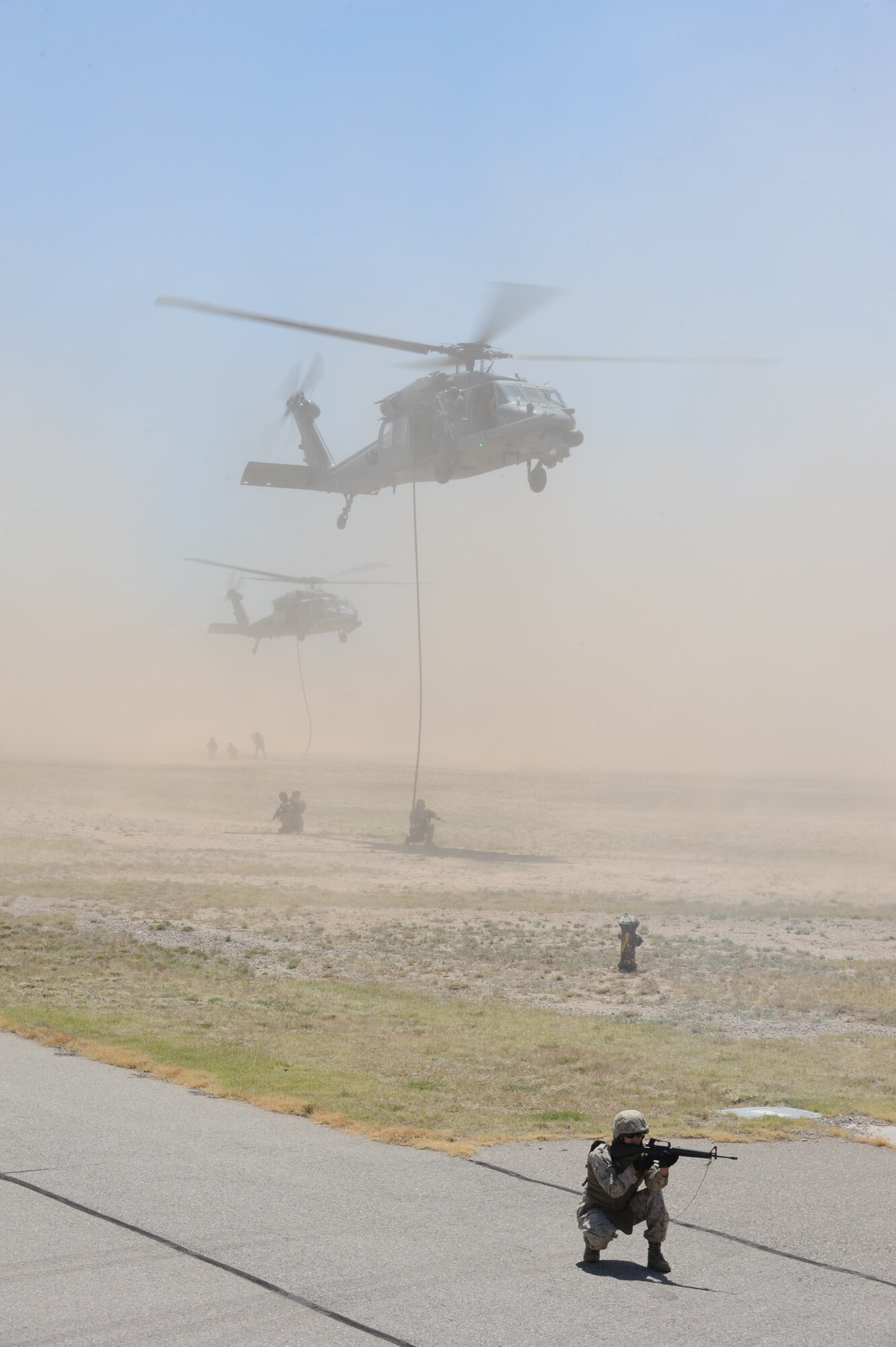Marines from Bulk Field Company Alpha, perform a combat search and rescue demonstration during the 2012 open house at Davis-Monthan Air Force Base, Ariz., April 15, 2012.  The marines were assisted by the 55th Rescue Squadron. (U.S. Air Force photo by Airman 1st Class Camilla Griffin/Released)