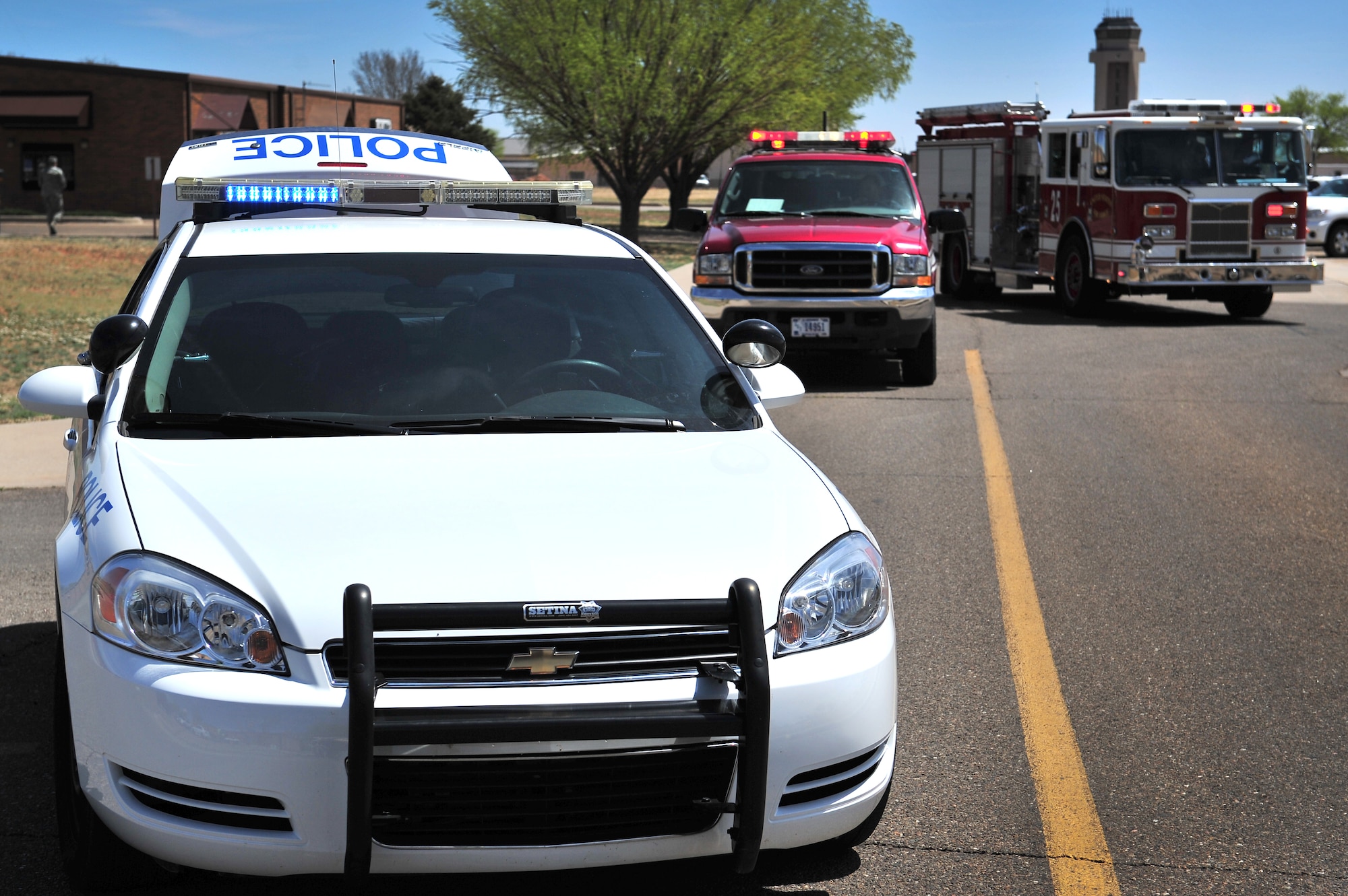 First responder vehicles gather at the scene of a simulated tornado during a natural disaster exercise at Cannon Air Force Base, N.M., April 5, 2012. Training exercises provide a safe and controlled environment to practice tactics, techniques and procedures. (U.S. Air Force photo by Tech. Sgt. Josef Cole)