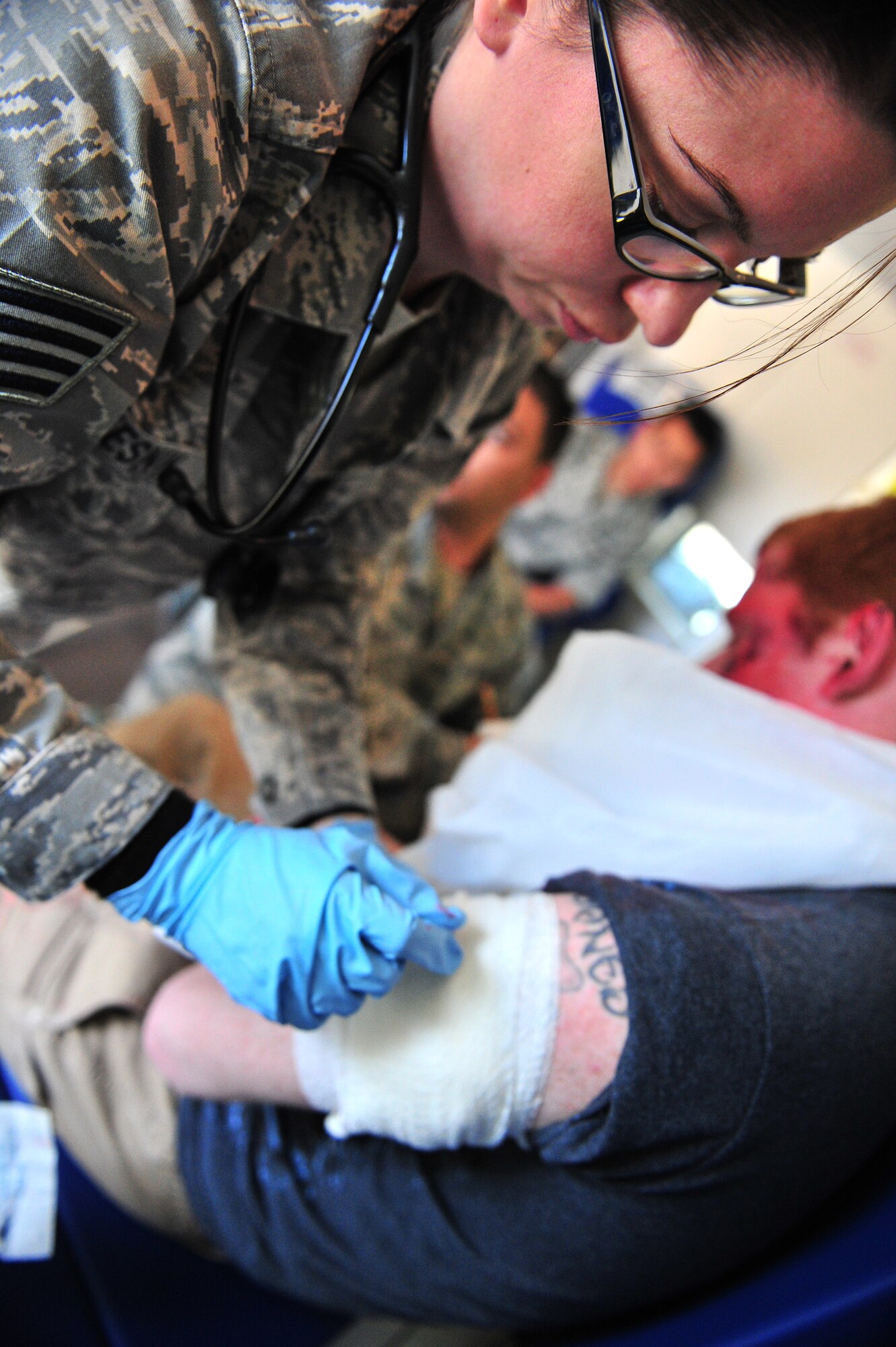 U.S. Air Force Staff Sgt. Alaina Kolesnik, 27th Special Operations Medical Group medical technician, treats simulated tornado victim Senior Airman Frank Jones during a natural disaster exercise at Cannon Air Force Base, N.M., April 5, 2012. Training exercises provide a safe and controlled environment to practice tactics, techniques and procedures. (U.S. Air Force photo by Tech. Sgt. Josef Cole)