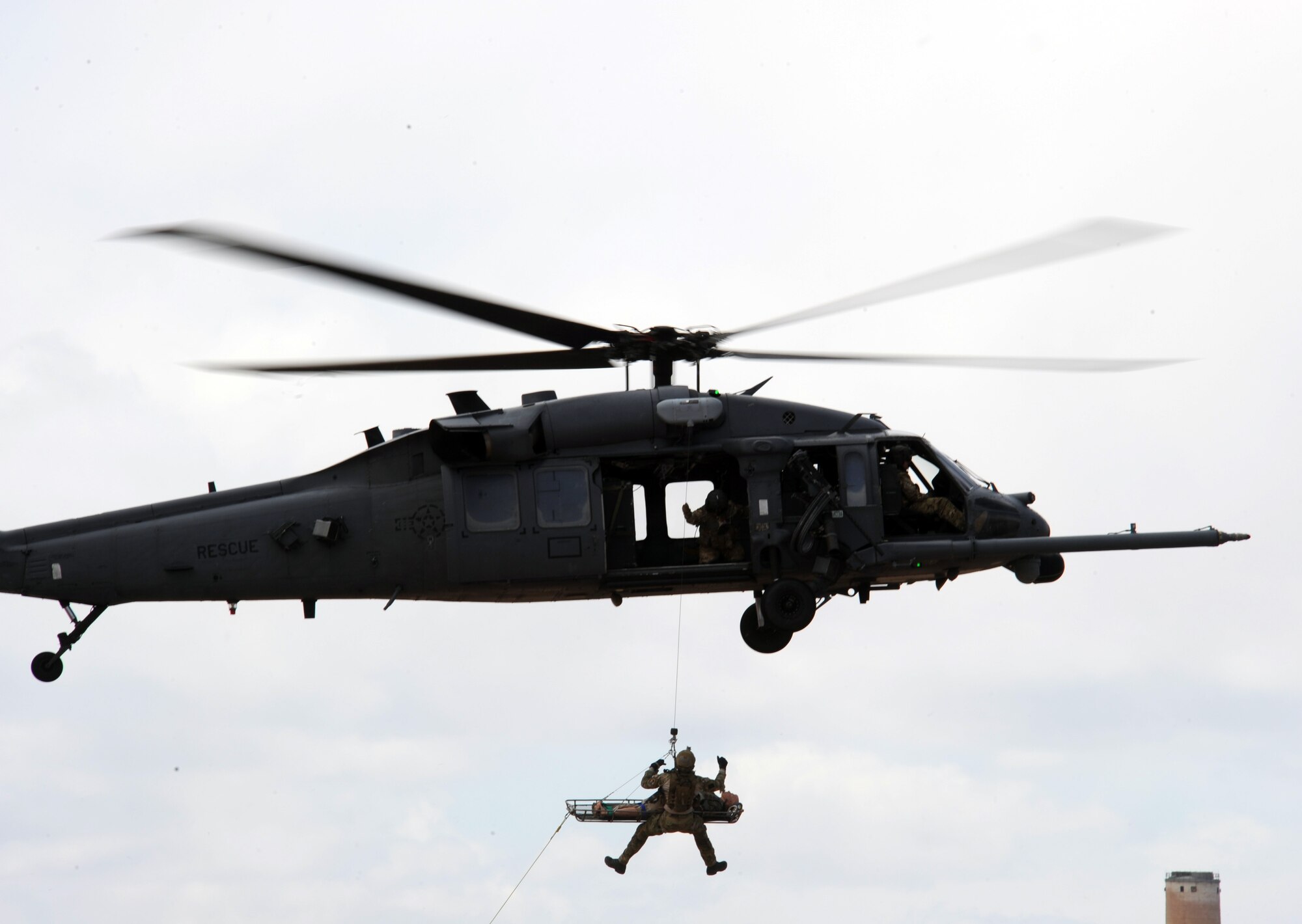 A U.S. Marine Corps Marine guides a dummy casualty into an HH-60 Pave Hawk during the combat search and rescue demonstration during the open house on Davis-Monthan Air Force Base, Ariz., April 14, 2012. The CSAR demonstration showed how air and ground forces coordinate to get injured and stranded personnel out of a hostile area. (U.S. Air Force Photo by Airman 1st Class Timothy D. Moore/Released)
