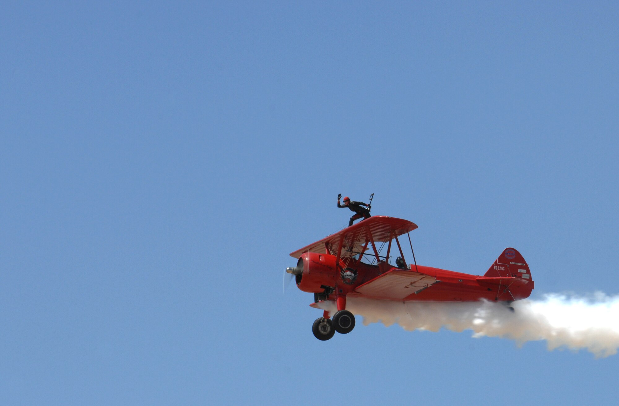 Carol Pilon, a wing walker from Third Strike Wingwalking, does a demonstration on Davis-Monthan Air Force Base, Ariz., April 13, 2012. Pilon was a performer in the Davis-Monthan open house. (U.S. Air Force photo by Airman 1st Class Josh Slavin/ Released)