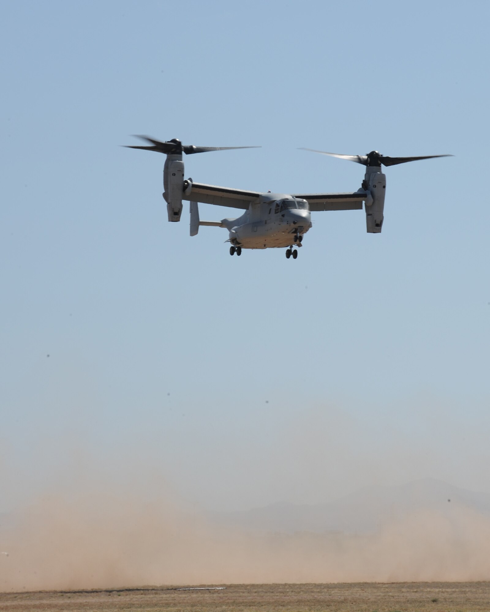 A U.S. Marine Corps MV-22 Osprey hovers over the ground during an aerial demonstration at the open house practice on Davis-Monthan Air Force Base, Ariz., April 13, 2012. The D-M Thunder and Lightning Over Arizona air show showcased several aircrafts and teams from all U.S. Armed Forces as well as civilian acts. (U.S. Air Force photo by Airman 1st Class Timothy D. Moore/Released)