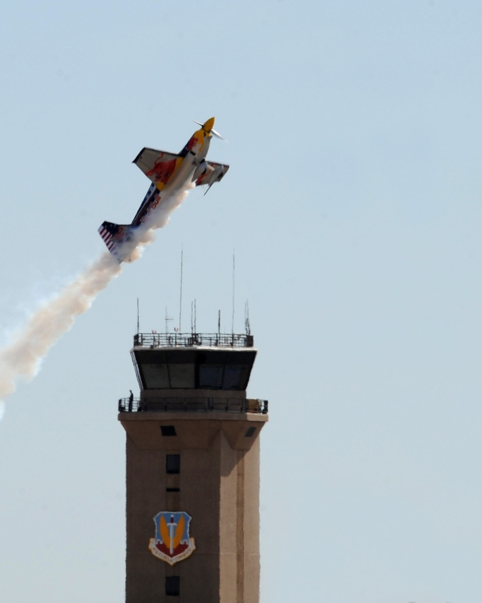 The Red Bull Air Force demonstration team plane passes over the Air Traffic Control Tower during practice for the 2012 open house at Davis-Monthan Air Force Base, Ariz., April 13, 2012. The Friday practice was open to military members and their guests.  (U.S. Air Force photo by Senior Airman Brittany Dowdle)