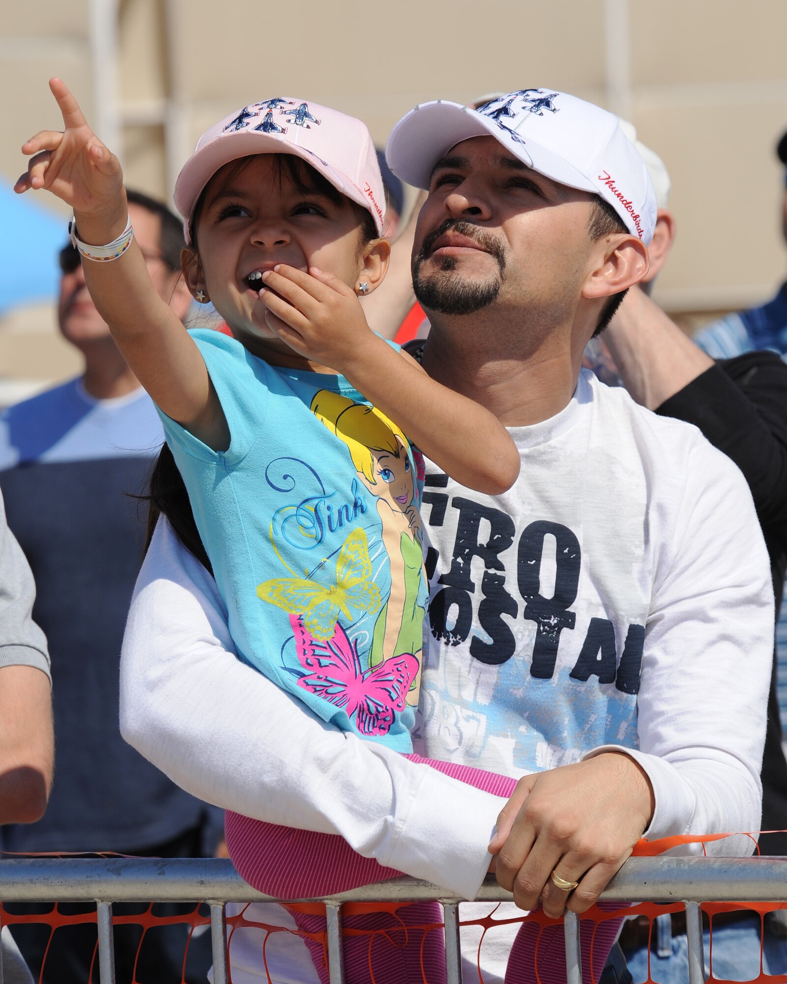 Geraldine Tello gets excited with her father, Elvis, as they watch the U.S. Air Force Thunderbird demonstration team fly over the spectators at the 2012 open house at Davis-Monthan Air Force Base, Ariz., April 15, 2012. More than 130,000 people came out to this year’s open house. (U.S. Air Force photo by Senior Airman Brittany Dowdle)