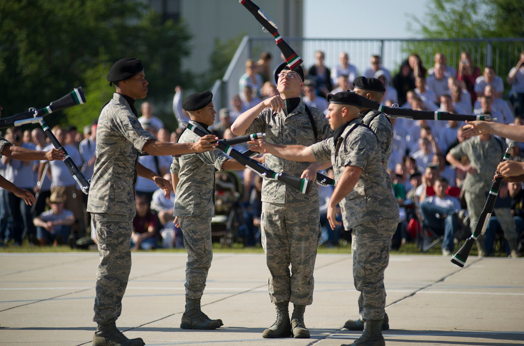 The 334th Training Squadron drill team, toss rifles to one another during their freestyle routine April 13, 2012, at Keesler Air Force Base, Miss., on the drill pad. Friday’s drill down was the first quarterly competition of the season.  (U.S. Air Force photo by Adam Bond)