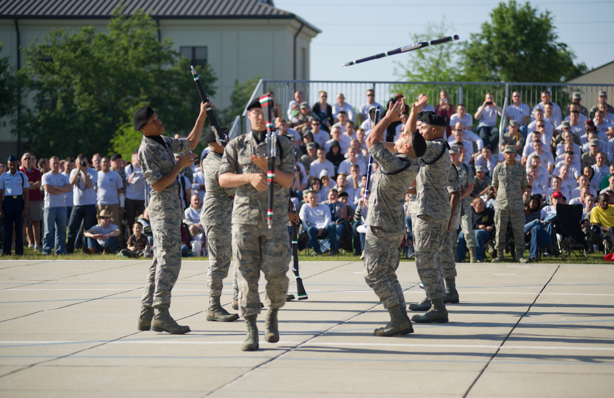 The 334th Training Squadron drill team, toss rifles to one another during their freestyle routine April 13, 2012, at Keesler Air Force Base, Miss., on the drill pad. Friday’s drill down was the first quarterly competition of the season.  (U.S. Air Force photo by Adam Bond)