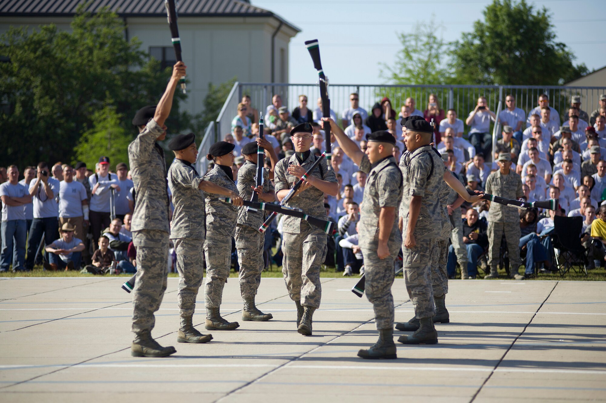The 334th Training Squadron drill team, toss rifles to one another during their freestyle routine April 13, 2012, at Keesler Air Force Base, Miss., on the drill pad. Friday’s drill down was the first quarterly competition of the season.  (U.S. Air Force photo by Adam Bond)
