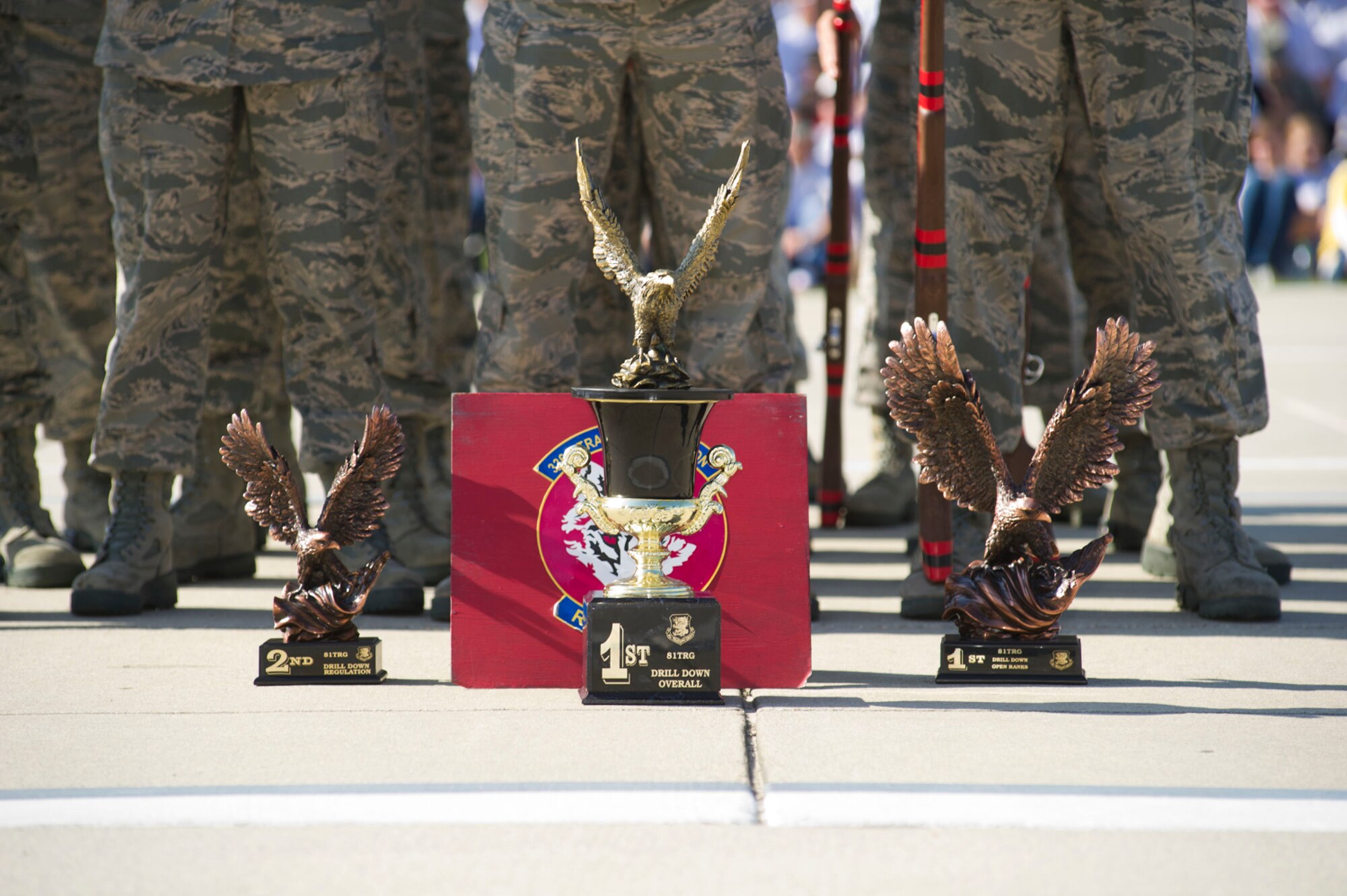 Three trophies rest in front of the 336th Training Squadron Red Wolves drill team April 13, 2012, on the drill pad behind the Levitow Training Support Facility at Keesler Air Force Base, Miss.  The team placed second in regulation drill, first in open ranks and first overall.  (U.S. Air Force photo by Adam Bond)