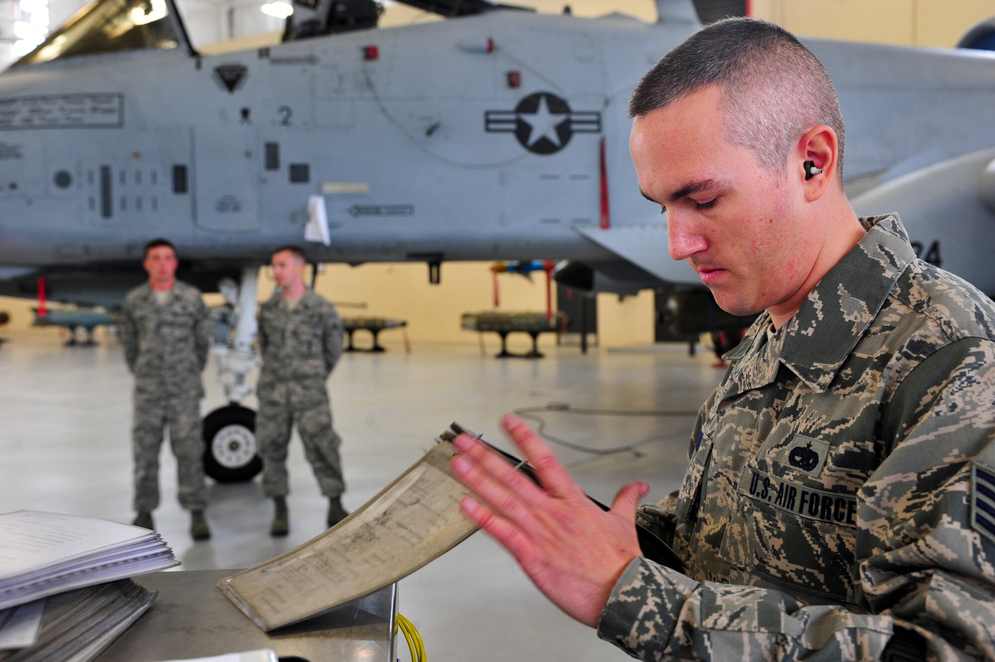 U.S. Air Force Staff Sgt. George Lesko, 23d Aircraft Maintenance Squadron, 74th Aircraft Maintenance Unit weapons load crew member, goes over a final checklist during a quarterly weapons load crew competition at Moody Air Force Base, Ga., April 13, 2012. Lesko and his crew competed against the 75th AMU to determine who could load ammunition the quickest and most efficiently onto an A-10C Thunderbolt II. (U.S. Air Force photo by Staff Sgt. Stephanie Mancha/Released)
