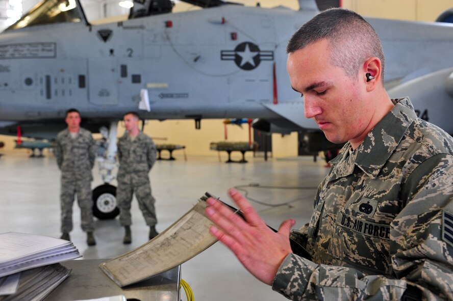 U.S. Air Force Staff Sgt. George Lesko, 23d Aircraft Maintenance Squadron, 74th Aircraft Maintenance Unit weapons load crew member, goes over a final checklist during a quarterly weapons load crew competition at Moody Air Force Base, Ga., April 13, 2012. Lesko and his crew competed against the 75th AMU to determine who could load ammunition the quickest and most efficiently onto an A-10C Thunderbolt II. (U.S. Air Force photo by Staff Sgt. Stephanie Mancha/Released)

