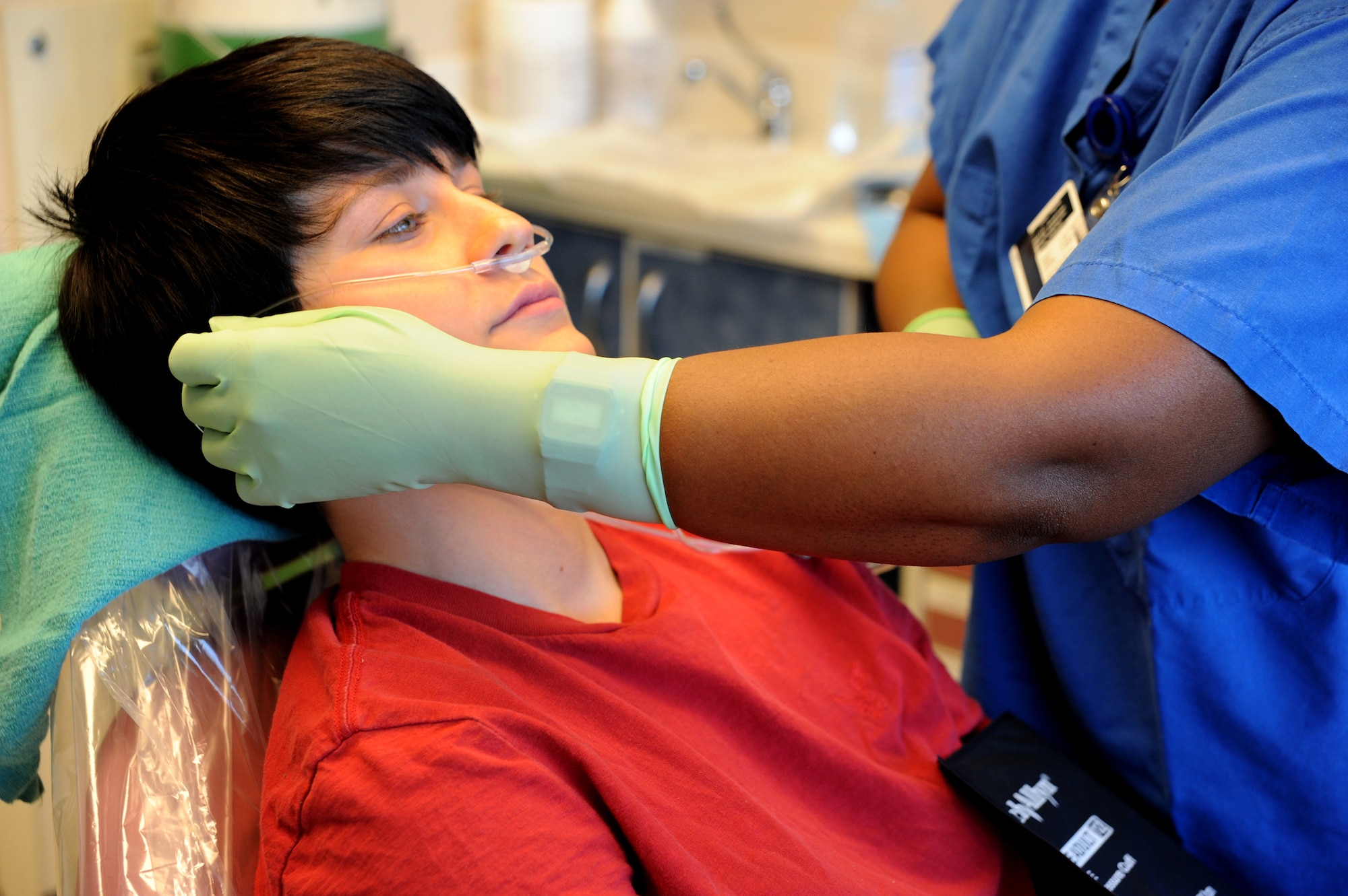 Tanya Maisonet places an oxygen tube on Senior Airman Chaley Dyer as she prepares for a wisdom tooth extraction at Joint Base Charleston - Air Base April 11. Before a wisdom tooth extraction, the dentist gives the patient a local anesthetic which numbs the area where the tooth will be removed or general anesthetic which makes the patient sleep through the procedure. Maisonet is from the 628th Medical Group and Dyer is from the 628th Security Forces Squadron. (U.S. Air Force photo / Airman 1st Class Ashlee Galloway)