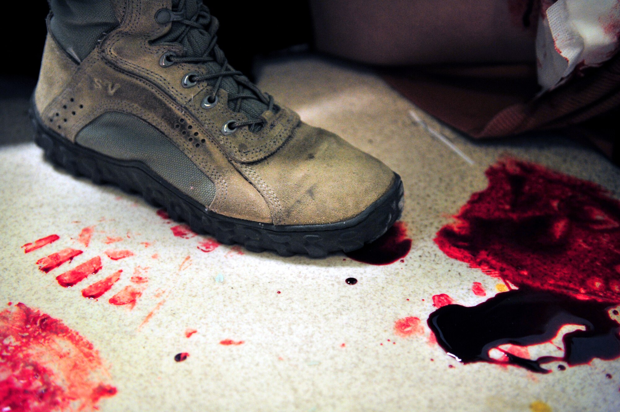 A first responder's boot leaves footprints in fake blood during a tornado natural disaster exercise at Cannon Air Force Base, N.M., April 5, 2012. Training exercises provide a safe and controlled environment to practice tactics, techniques and procedures. (U.S. Air Force photo by Tech. Sgt. Josef Cole)
