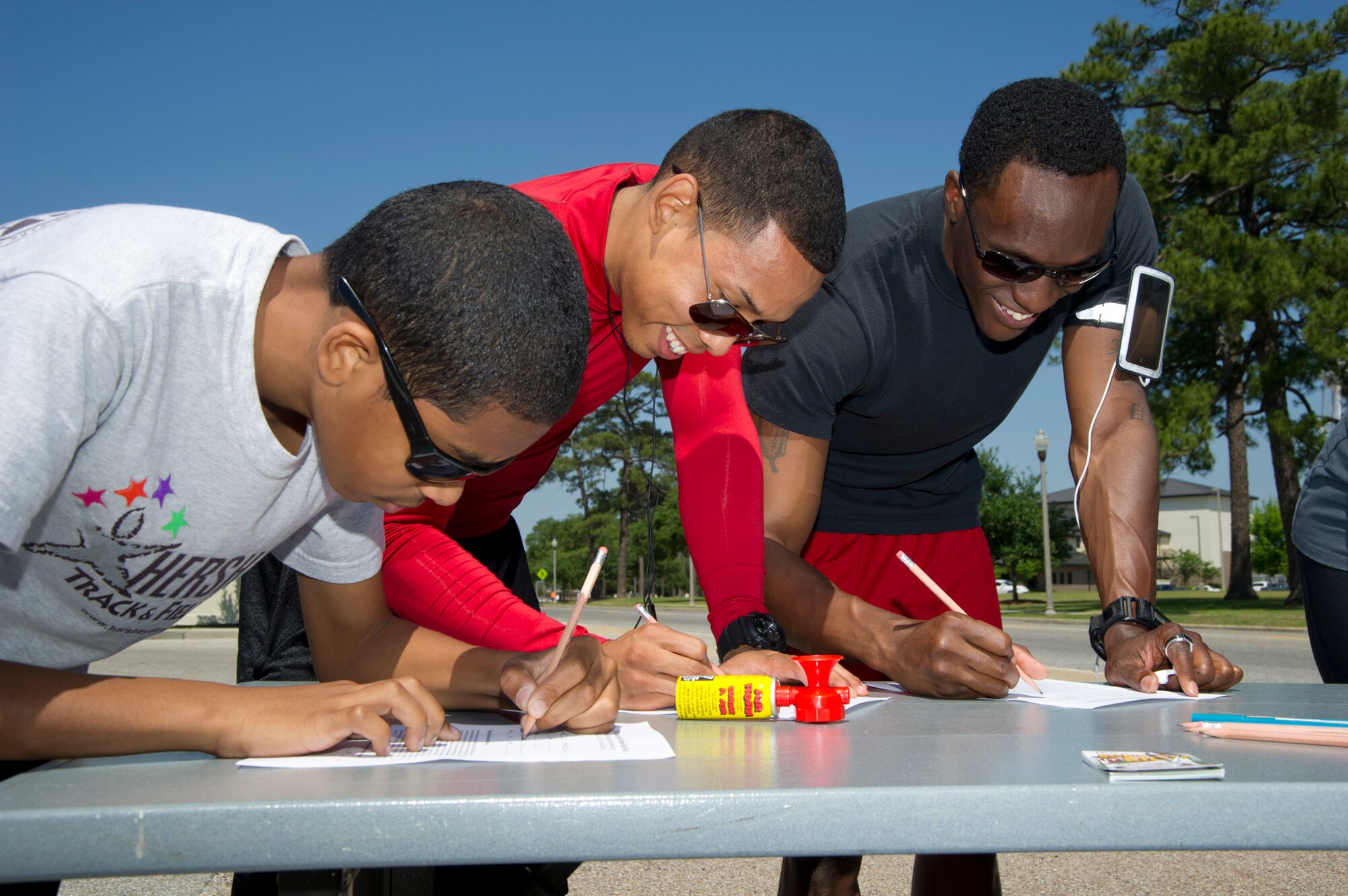 Brothers  Horace Pratt, 13; Mark Richardson, 81st Medical Support Squadron; and Freddie Smith, 81 Medical Operations Squadron, register for Keesler’s National Alcohol Awareness 5K run April 13, 2012, at Keesler Air Force Base, Miss.  (U.S. Air Force photo by Adam Bond)