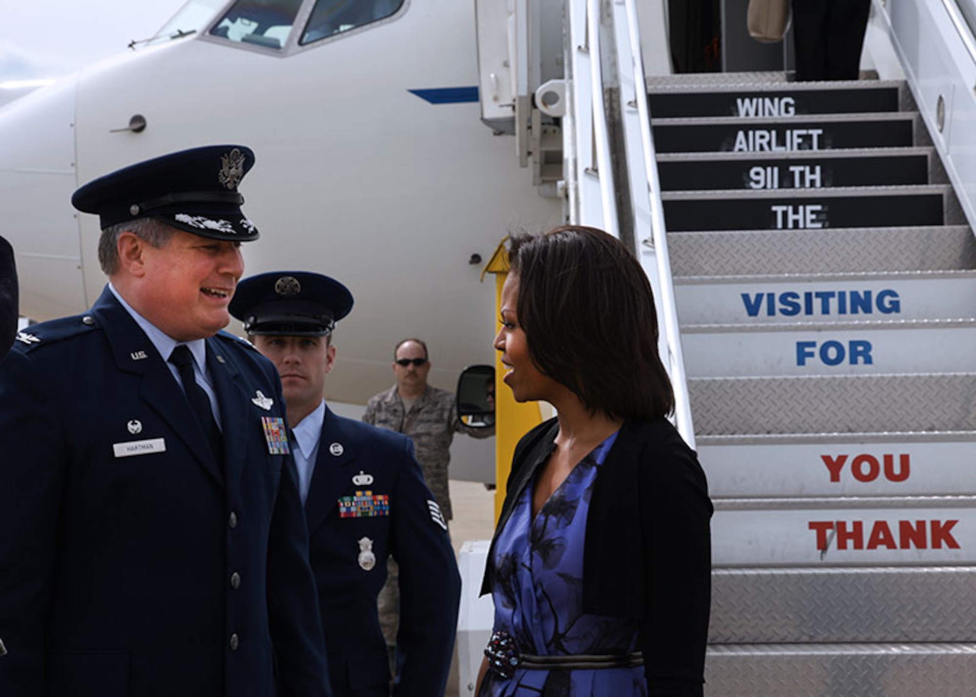 Col. Daryl Hartman, 911th Airlift Wing Operations Group commander, welcomes first lady Michelle Obama on her visit to the base, April 17, 2012. On the flight line, Mrs. Obama also shook hands with Senior Airman Dominic Mash, attached to the 911th Security Forces Squadron, and his family. Mash received the Air Force Achievement Medal in recognition for his service while deployed to Iraq and Afghanistan. (U.S. Air Force photo by Tech. Sgt. Ralph Van Houtem/Released) 