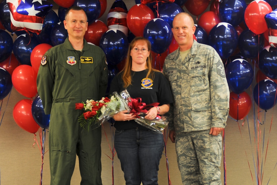 U.S. Air Force Col. Billy Thompson, 23d Wing commander, and Chief Master Sgt. Frank Batten, 23d WG command chief, present the Key Spouse of the Year award to Kristen Hopkins during the 2012 Annual Volunteer Recognition Ceremony at Moody Air Force Base, Ga., April 17, 2012. Hopkins served as a link between unit leadership and families by helping bridge communication gaps along with participating in many volunteer opportunities. (U.S. Air Force photo by Airman 1st Class Douglas Ellis/Released) 
