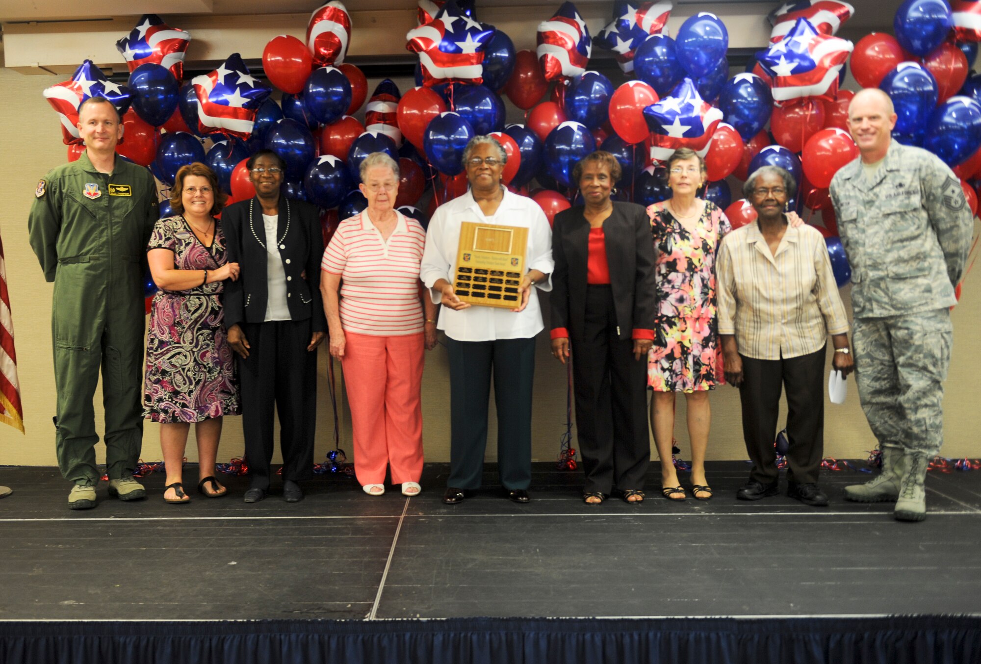 U.S. Air Force Col. Billy Thompson, 23d Wing commander, and Chief Master Sgt. Frank Batten, 23d WG command chief, present the Outstanding Volunteer Team award to Moody’s child development center and foster grandparent program members during the 2012 Annual Volunteer Recognition Ceremony at Moody Air Force Base, Ga., April 17, 2012. The group volunteered a total of 8,621 hours last year. (U.S. Air Force photo by Airman 1st Class Douglas Ellis/Released)
