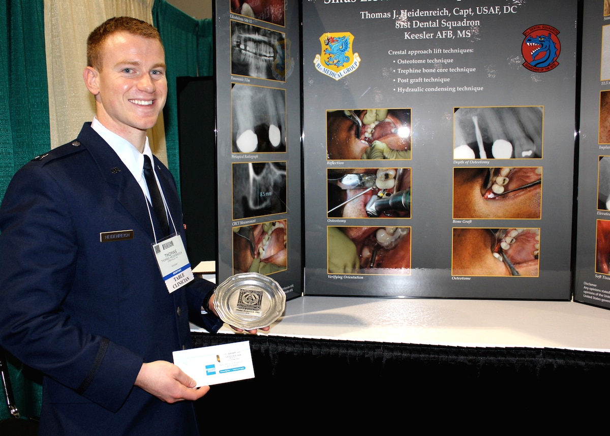 Capt. (Dr.) Thomas Heidenreich, 81st Dental Squadron, Keesler Air Force Base, Miss., stands with his award for “best in show” and the winning presentation at the Thomas P. Hinman Dental Meeting in Atlanta, Ga., March 22, 2012. The conference ran from March 22 thru 24 marking the program’s 100th anniversary and sessions covered dental topics ranging from materials to practice management.  (Courtesy photo)