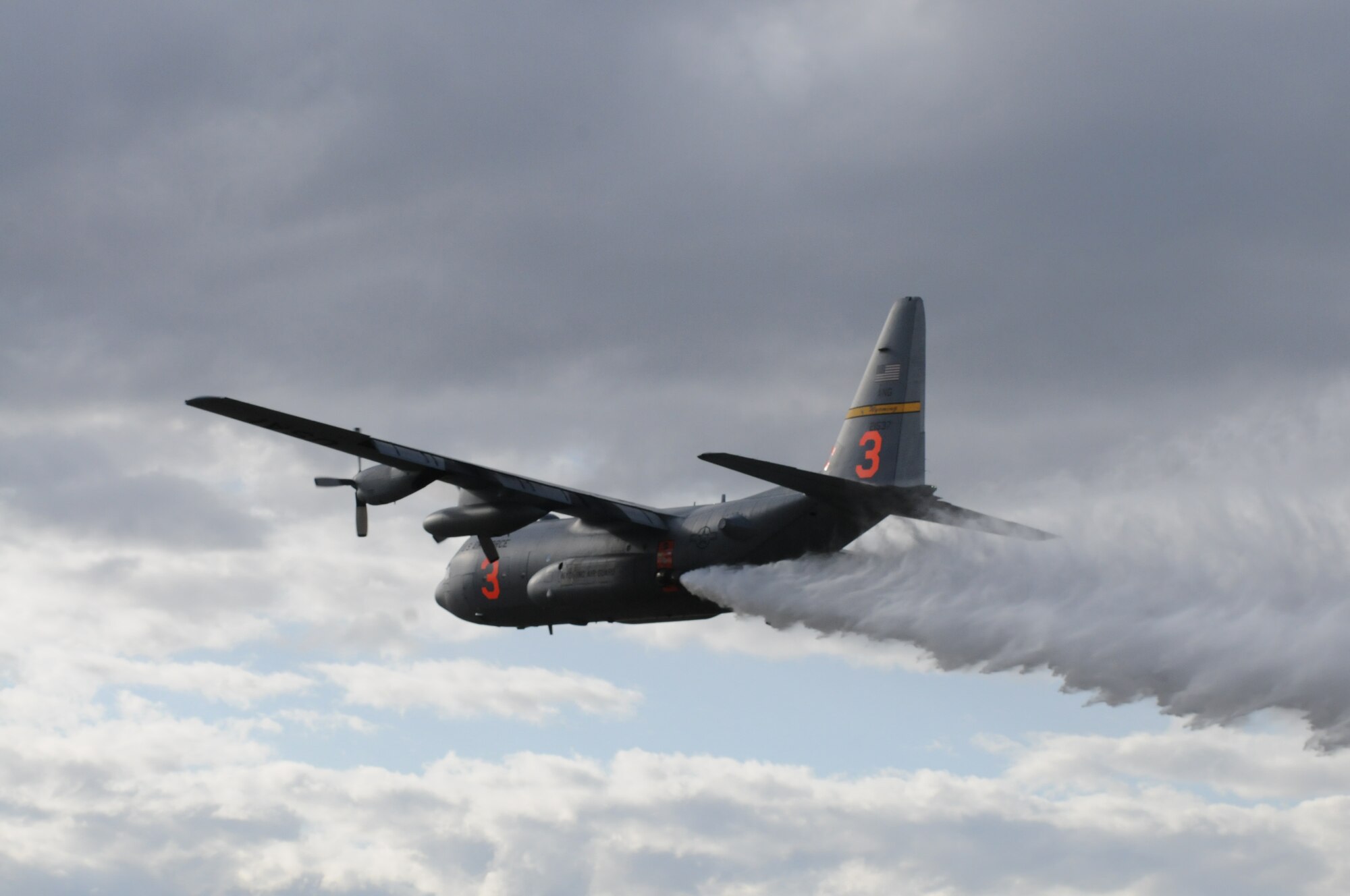 A C-130 assigned to the 153rd Airlift Wing, Wyoming Air National Guard, drops water during Modular Airborne Firefighting System (MAFFS) training April 16, 2012, over Camp Guernsey Joint Training Center, Wyo. Annual training is conducted to maintain currency and upgrade qualifications for pilots, aircrew and ground crews in preparation for the fire season. (Photo by Mr. Dewey Baars)