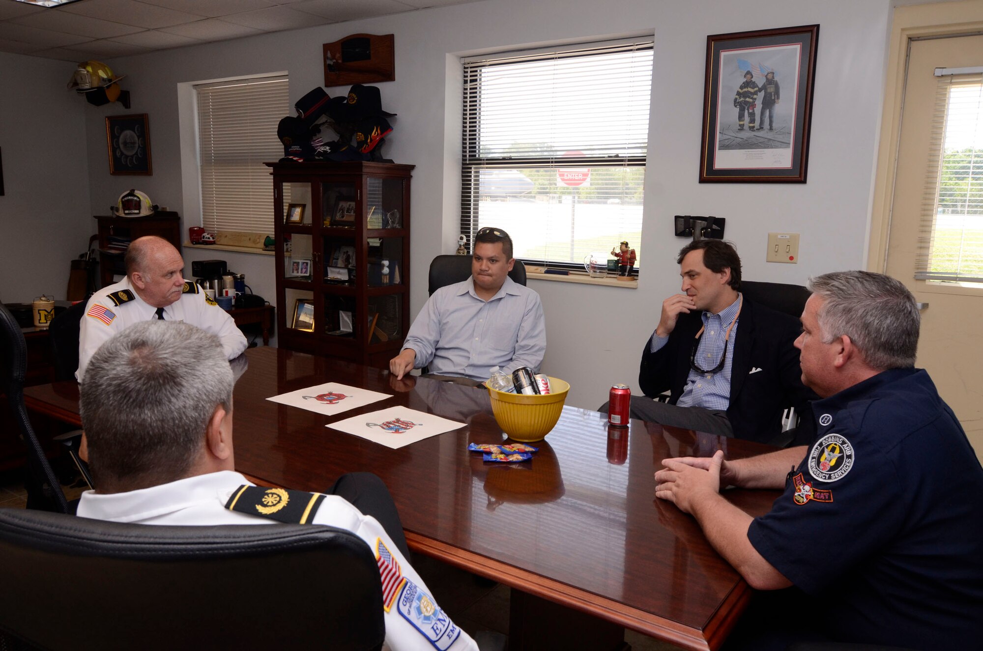 Congressional staff members, Tommy Nguyen and Trey Kilpatrick discuss the issues and improvements relating to the current fire station with Dobbins Fire personnel Apr. 9. (U.S. Air Force photo/Don Peek)