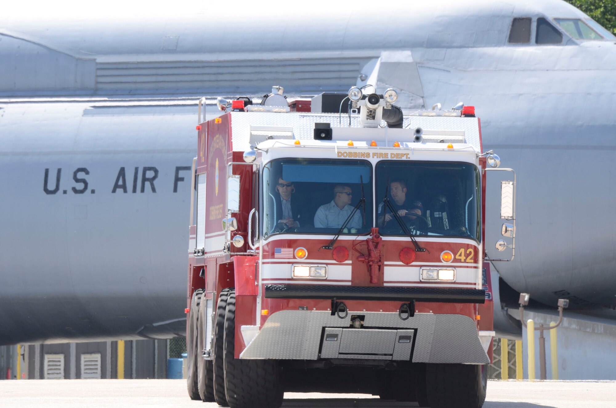 Patrick J. Cone, firefighter from the Dobbins Fire Department demonstrates the abilities of one of the crash response trucks to Tommy Nguyen and Trey Kilpatrick, staff members for Georgia Senator Johnny Isakson during his visit here April 9. (U.S. Air Force photo/Don Peek)